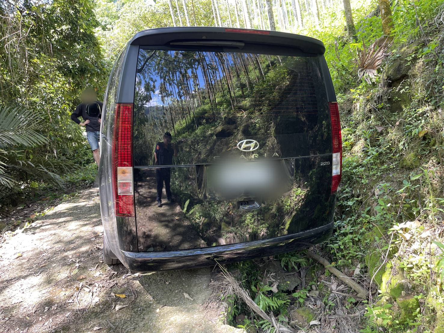 新加坡劉姓遊客帶妻小來台自駕觀光,在南投縣國姓鄉山區迷路且車輪陷進路邊泥土。(埔里分局提供)
