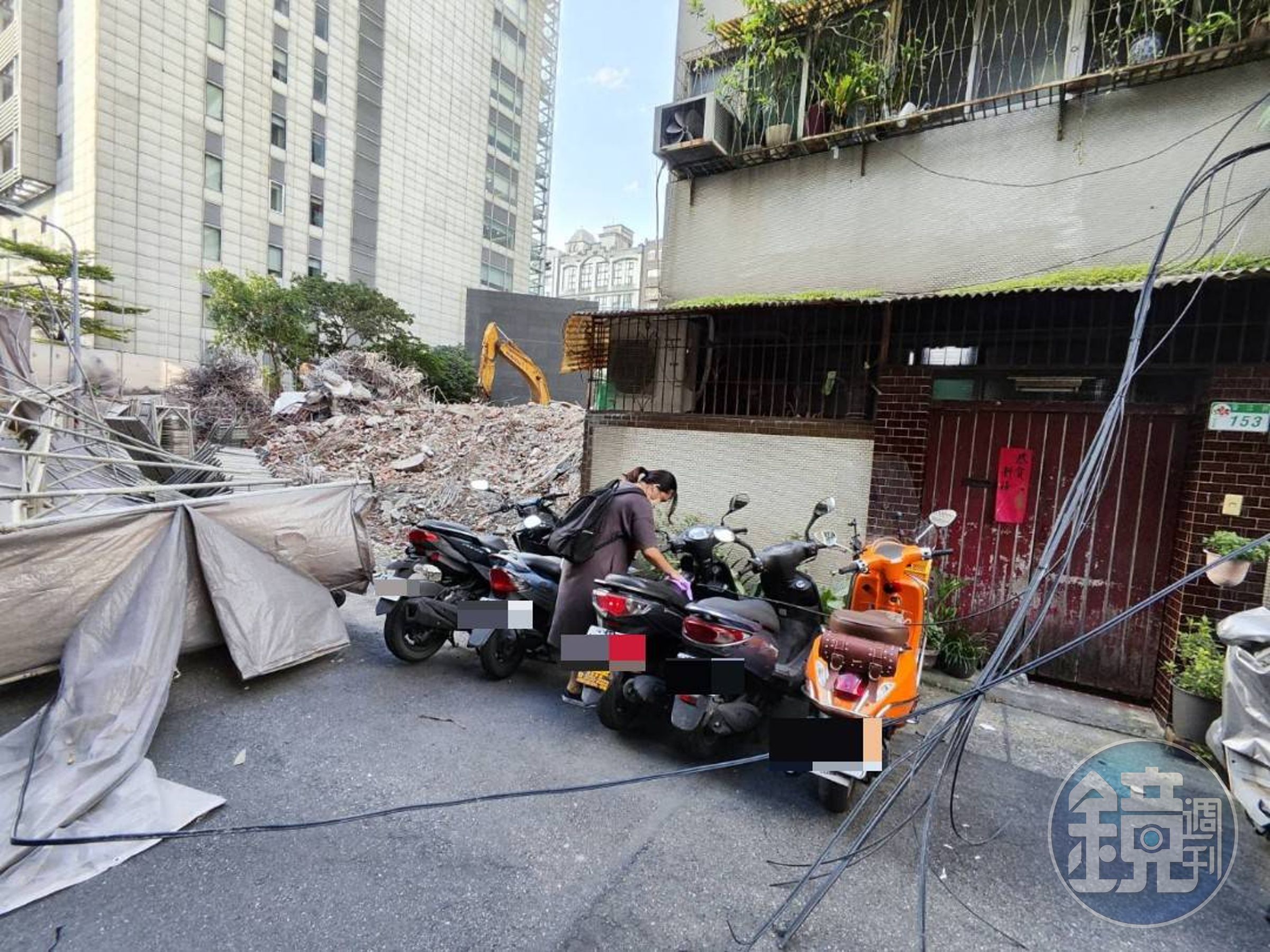 倒塌鷹架波及路邊機車,也把有線電視電纜扯下。(翻攝畫面)