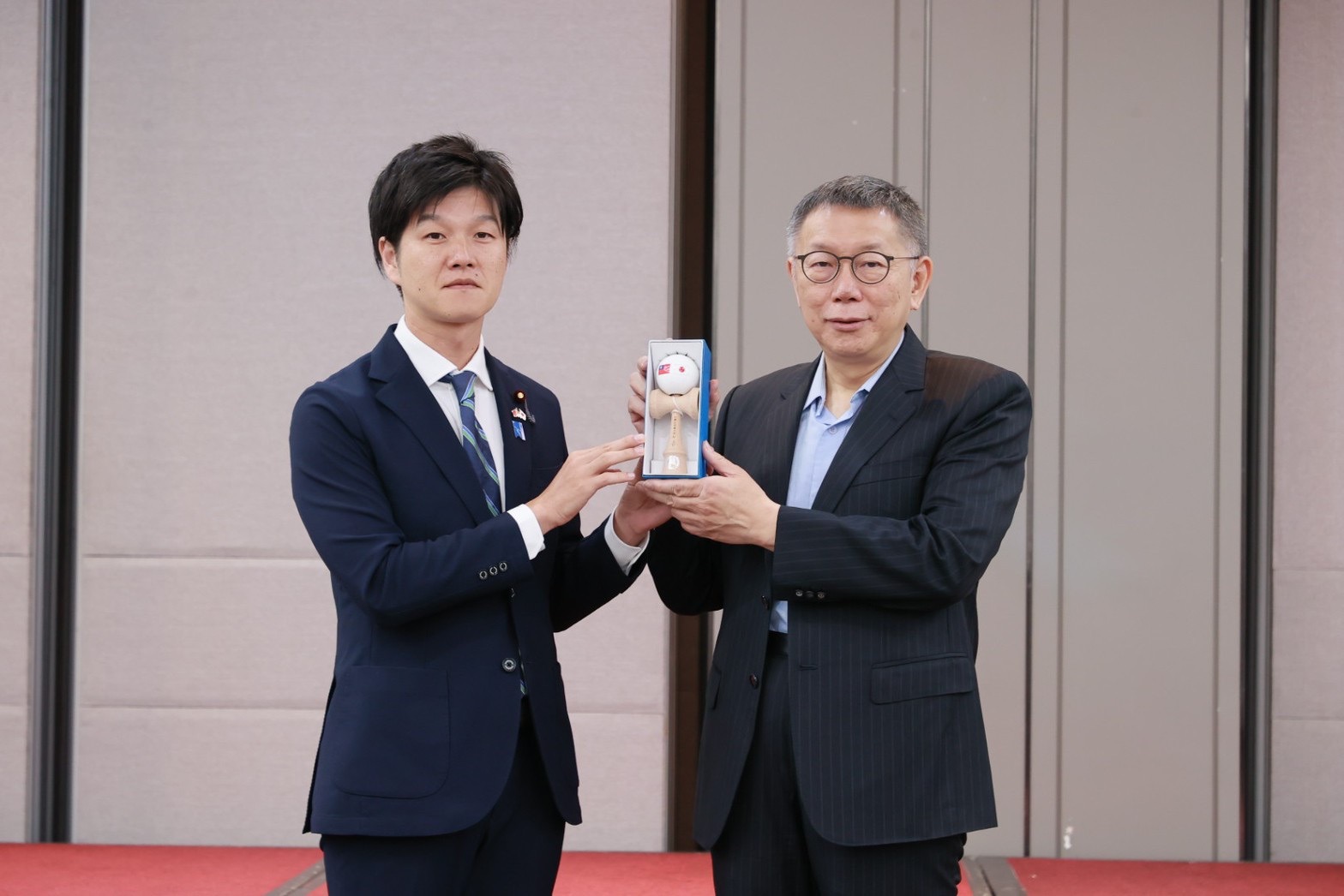 日本執政黨自民黨青年局長鈴木憲和（左）拜會柯文哲並致贈日本國寶「劍玉」。（民眾黨提供）