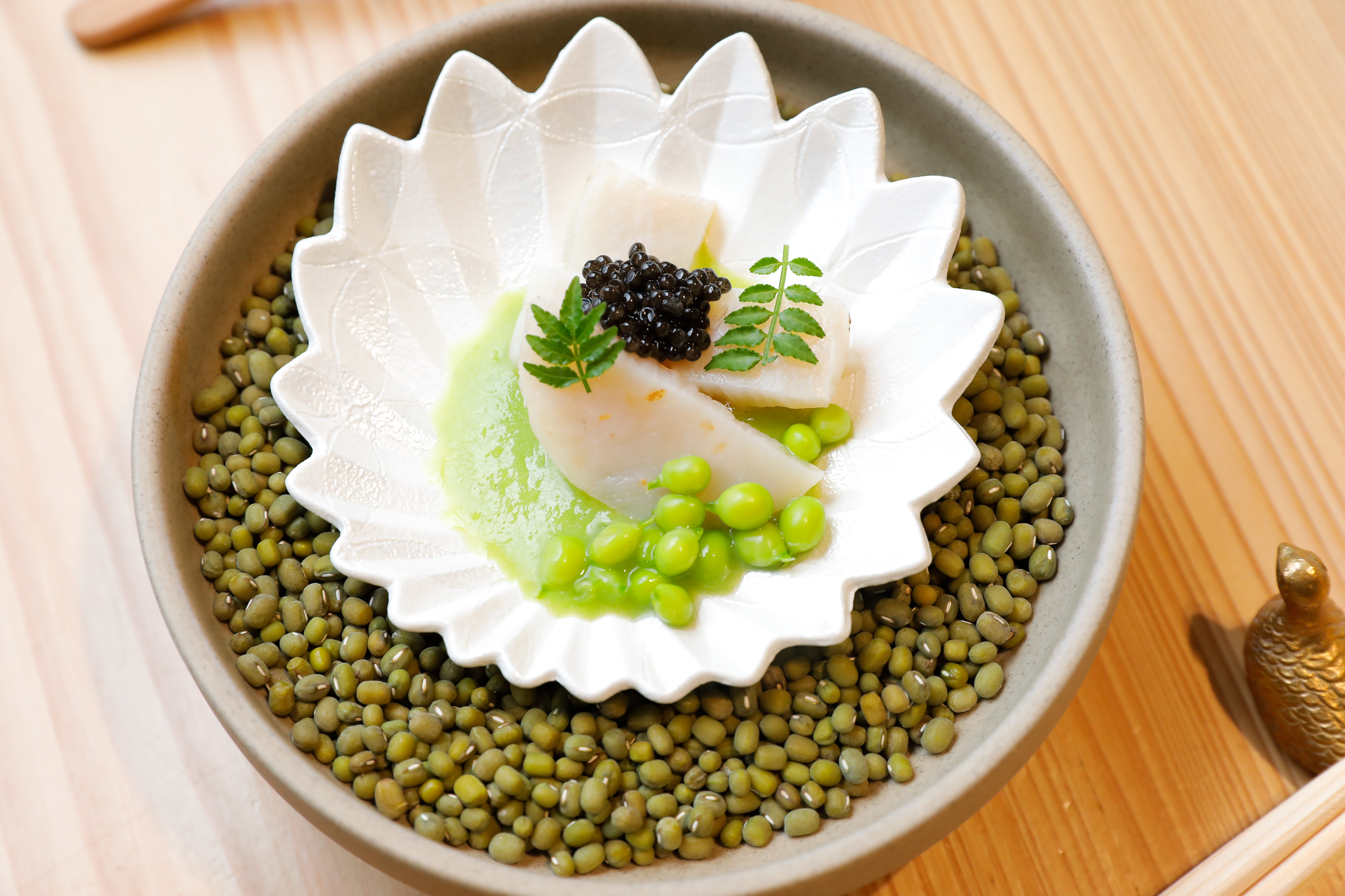 牛角貝燒用甜豆與魚子醬、木之芽搭配，吃進了一幅好風景。