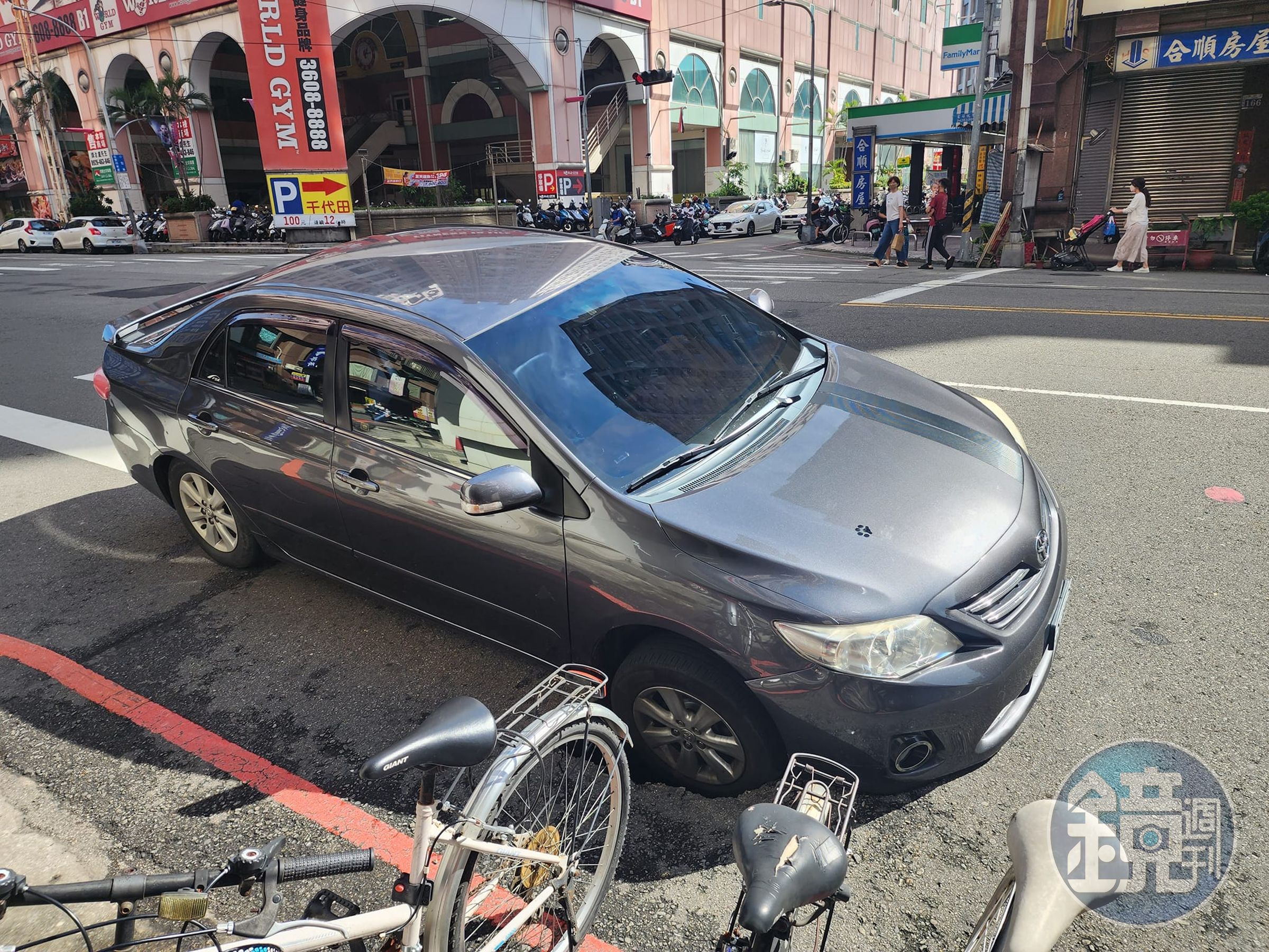 台中南區學府路上，今天有車子的右前輪被天坑吞噬，導致整台車輛動彈不得。（翻攝自爆料公社）