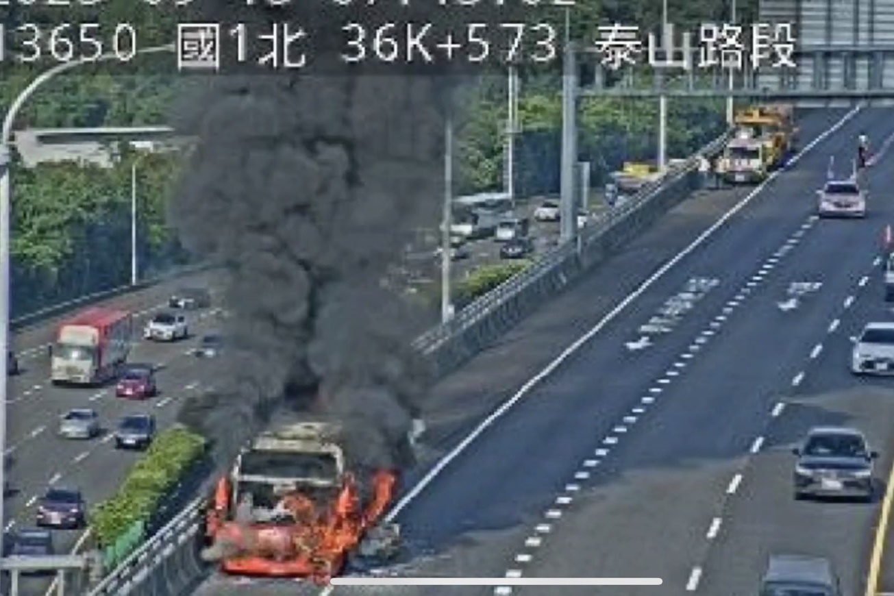 遊覽車被大火吞噬，濃煙烈焰一度造成車流回堵。（翻攝畫面）