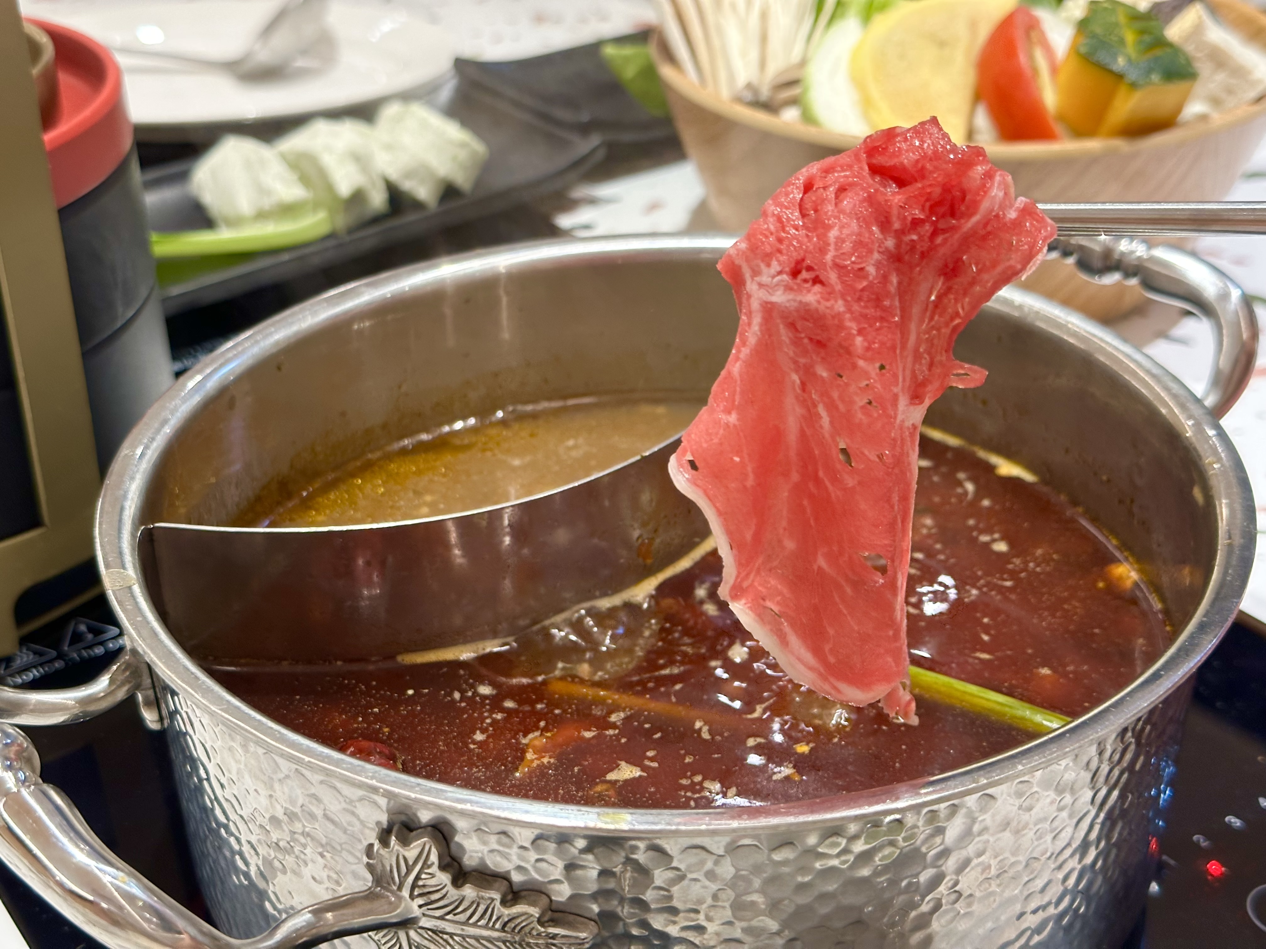 特殊湯底「麻辣靈魂鍋」油脂豐厚、辛辣帶勁，涮肉片很夠味。（需另加價38元）