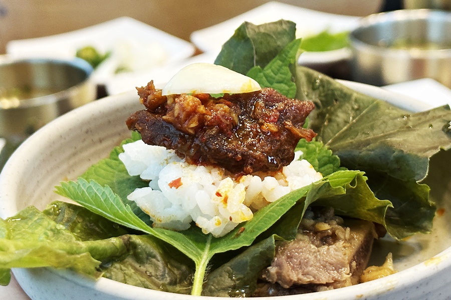 吃燉排骨除了能配白飯，韓國人也喜歡用生菜、紫蘇葉把排骨、白飯、生大蒜包在一起吃。