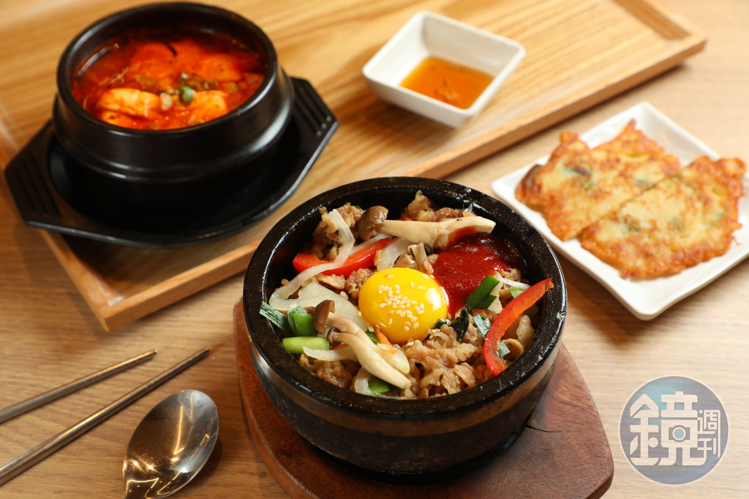 韓美膳半半套餐中的「豬五花石鍋拌飯&海鮮豆腐鍋」都以小鍋盛裝，套餐附上2小塊海鮮煎餅。（348元／份）