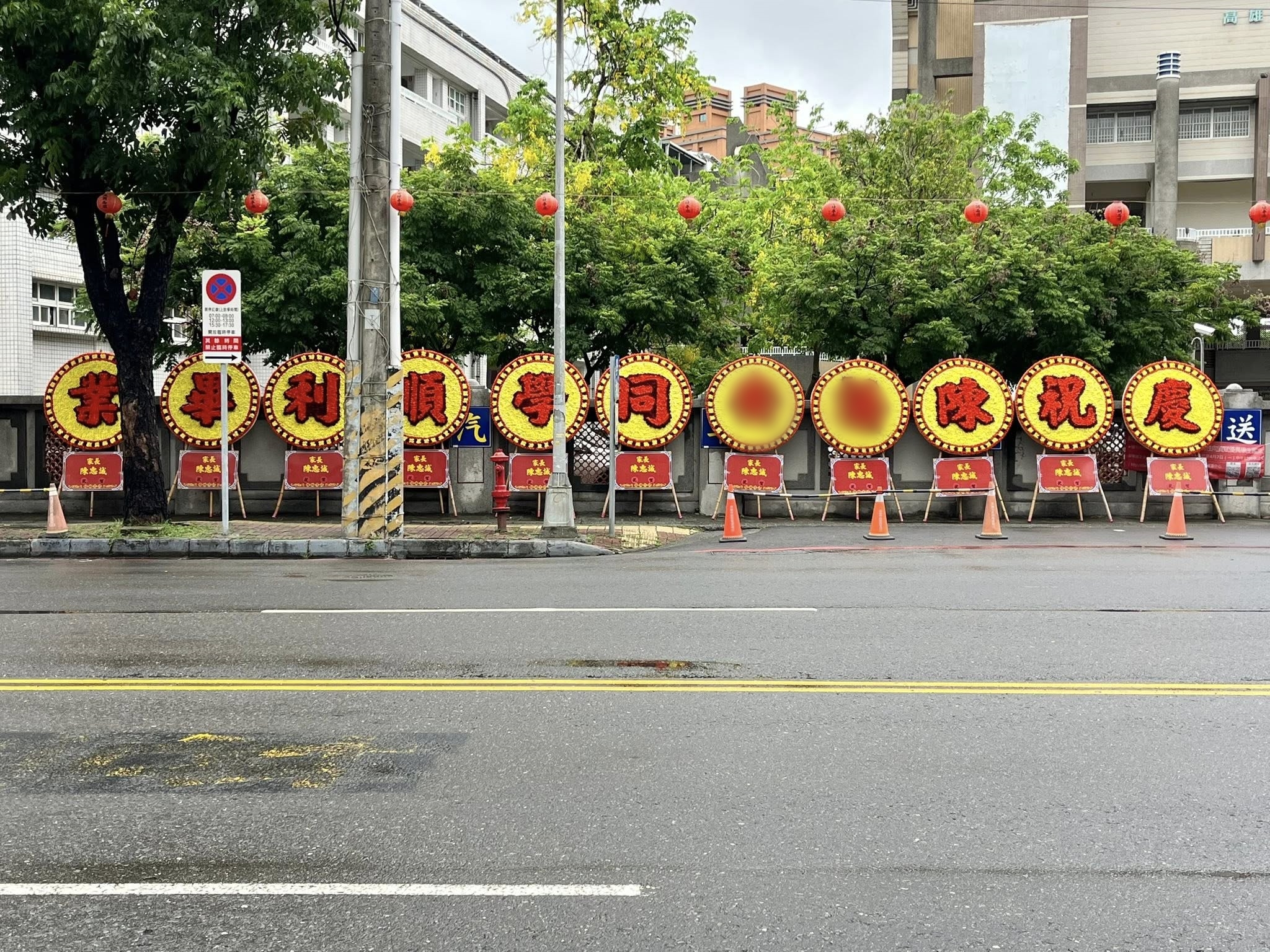 高雄楠梓國中一名爸爸為了慶祝女兒國中畢業，高調訂製了11個巨大花圈擺放在校門口。（翻攝臉書粉專「高雄點 Kaohsiungtien」）