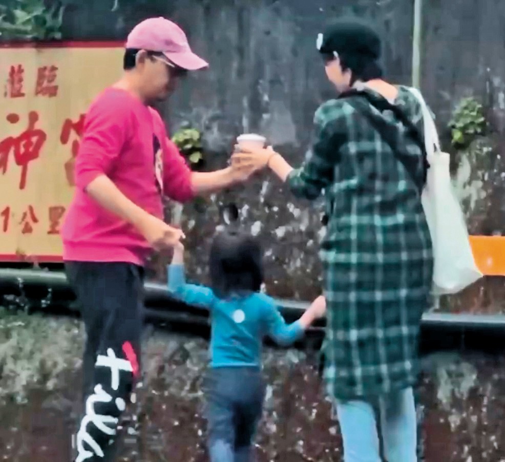 黃子佼將咖啡遞給孟耿如，準備要抱起女兒。（讀者提供）