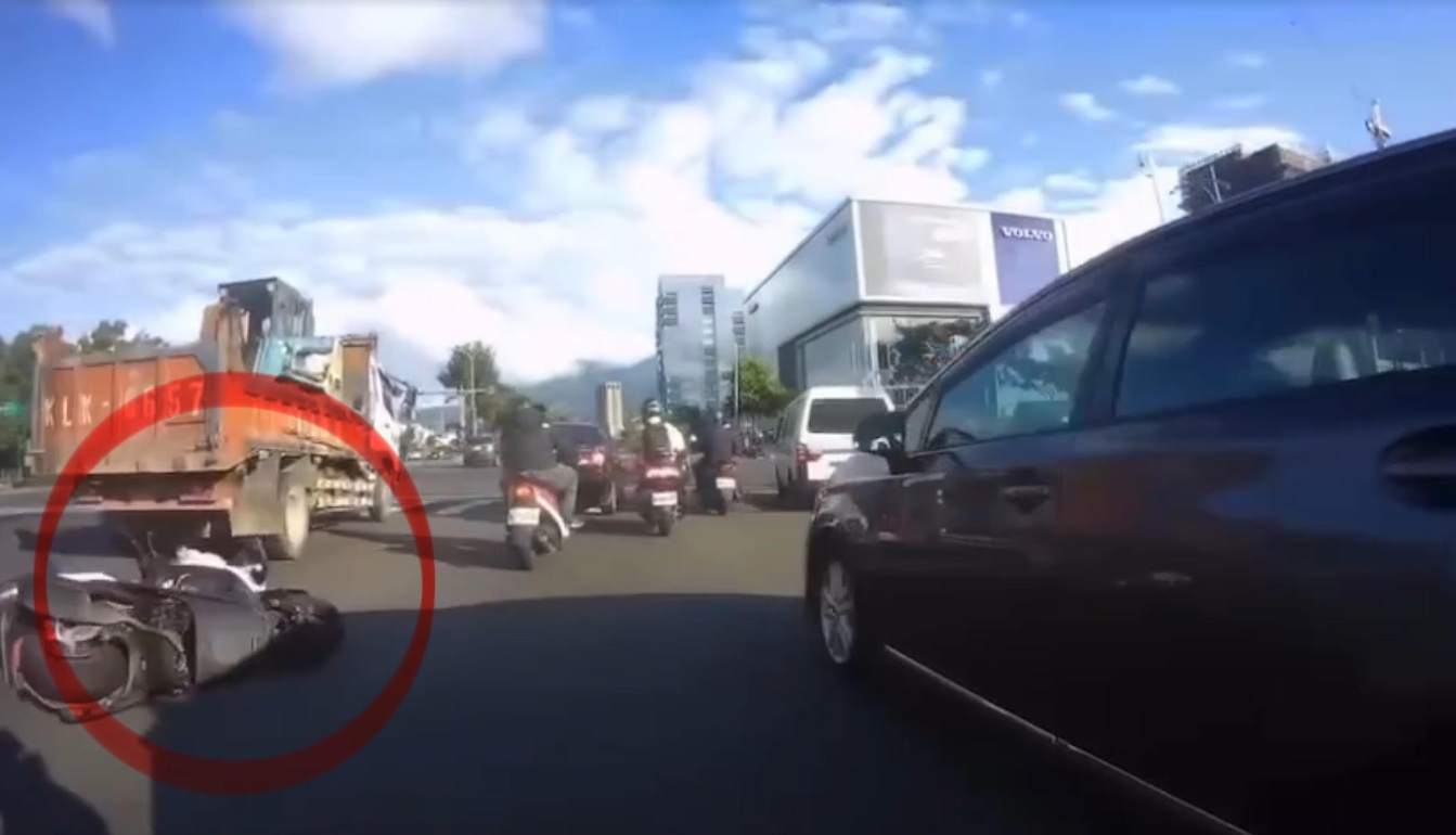 黃女機車倒地後，被後方大卡車輾過。（翻攝畫面）