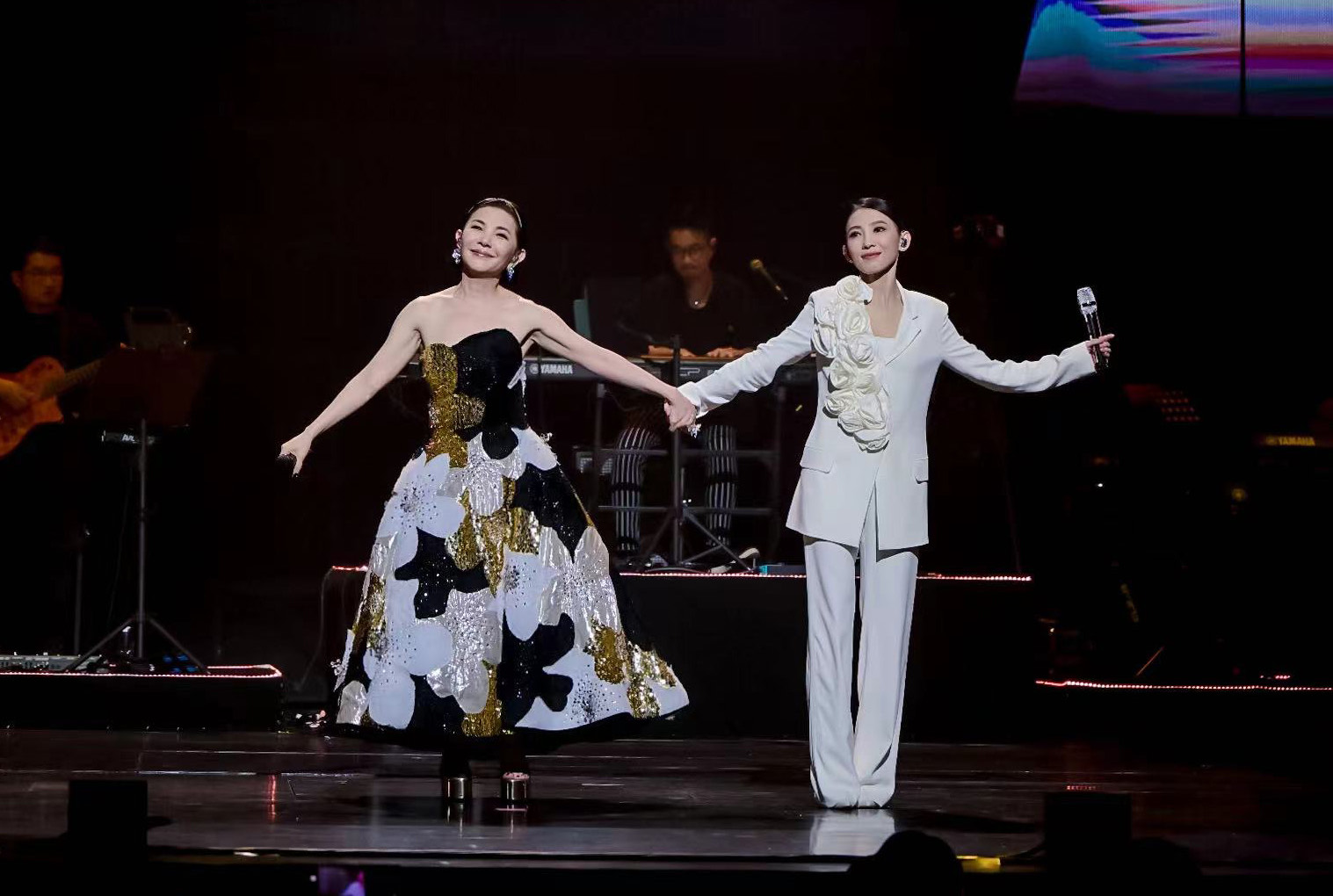 當演唱〈這些日子以來〉時，戴佩妮一身白色西裝帥氣現身，與張清芳手牽手。（上引娛樂提供）