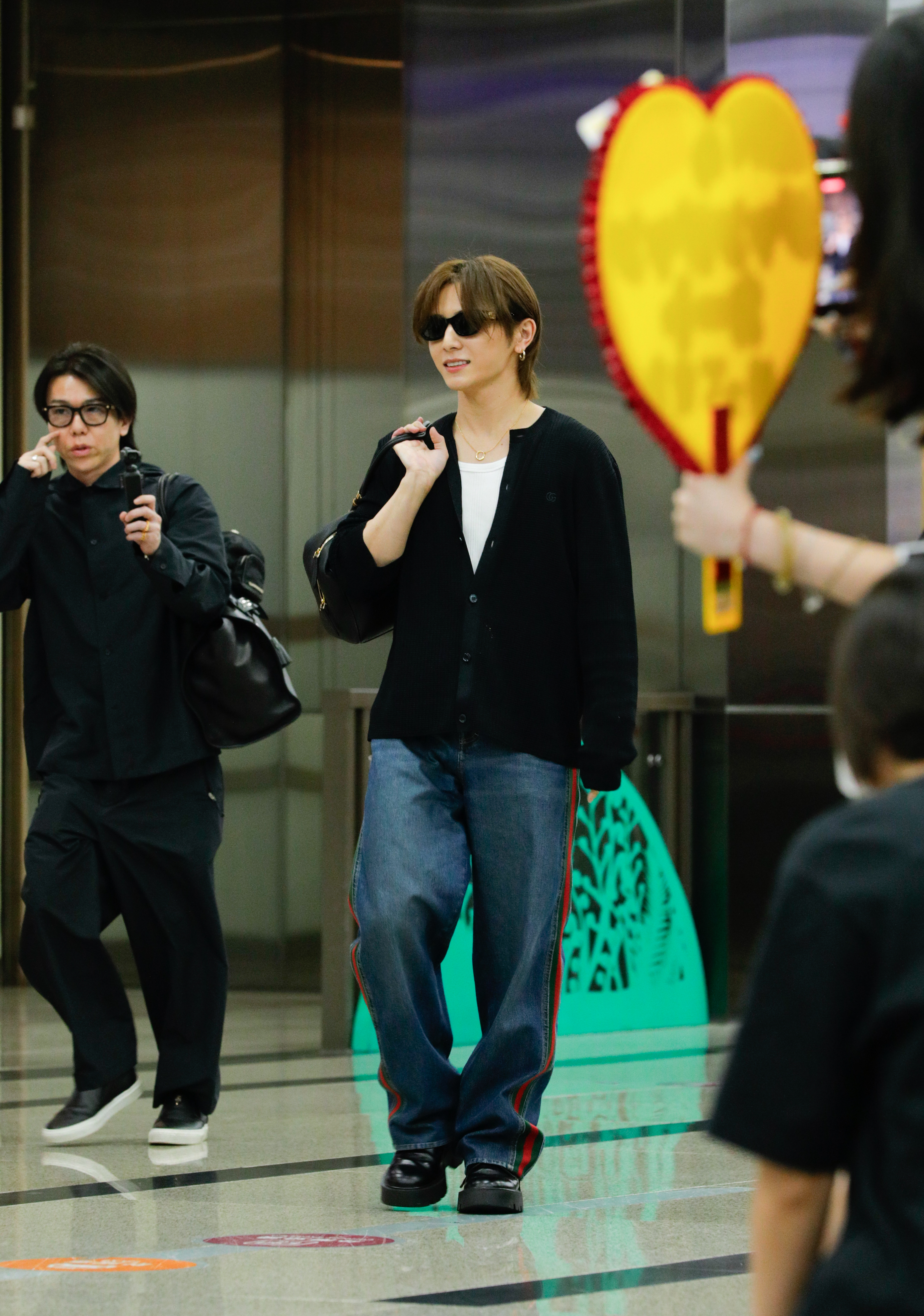 山田涼介戴著墨鏡、手提GUCCI竹節波士頓包現身松山機場。