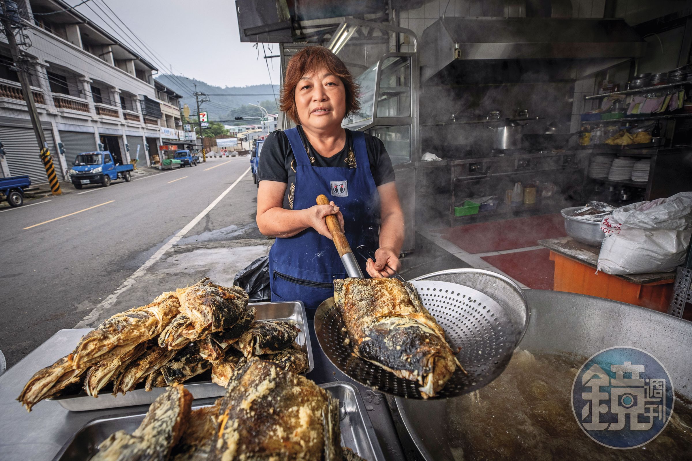 清晨5點多,砂鍋魚頭一條街仍冷清,江明苓隻身在店前馬路邊煮白斬雞、炸魚頭,10度低溫下卻大汗淋漓。