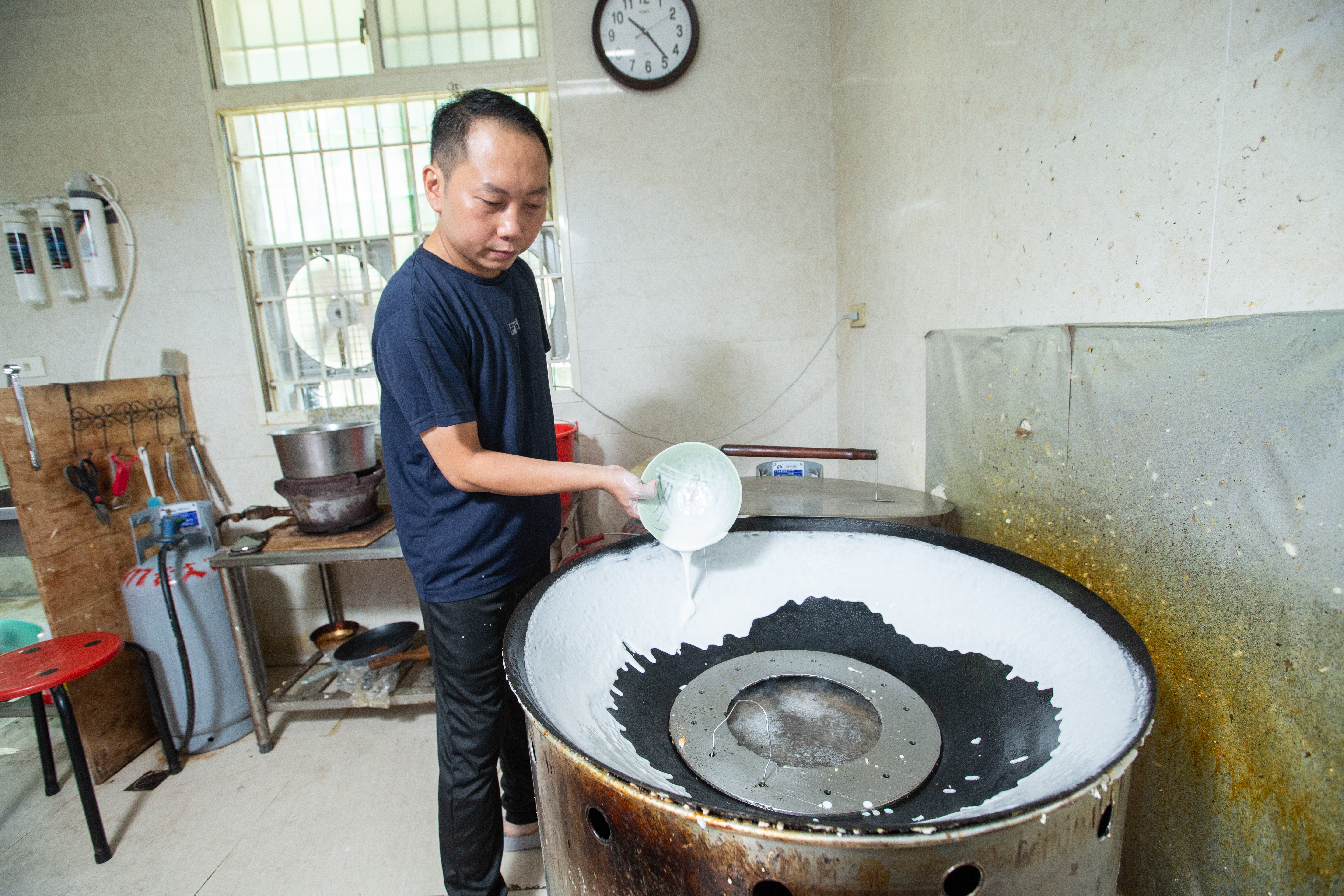 唐茂檳花了2年才學會製作鼎邊趖，用白蘿蔔蘸香油抹鍋後淋入調好的在來米漿，動作得快、穩、準。