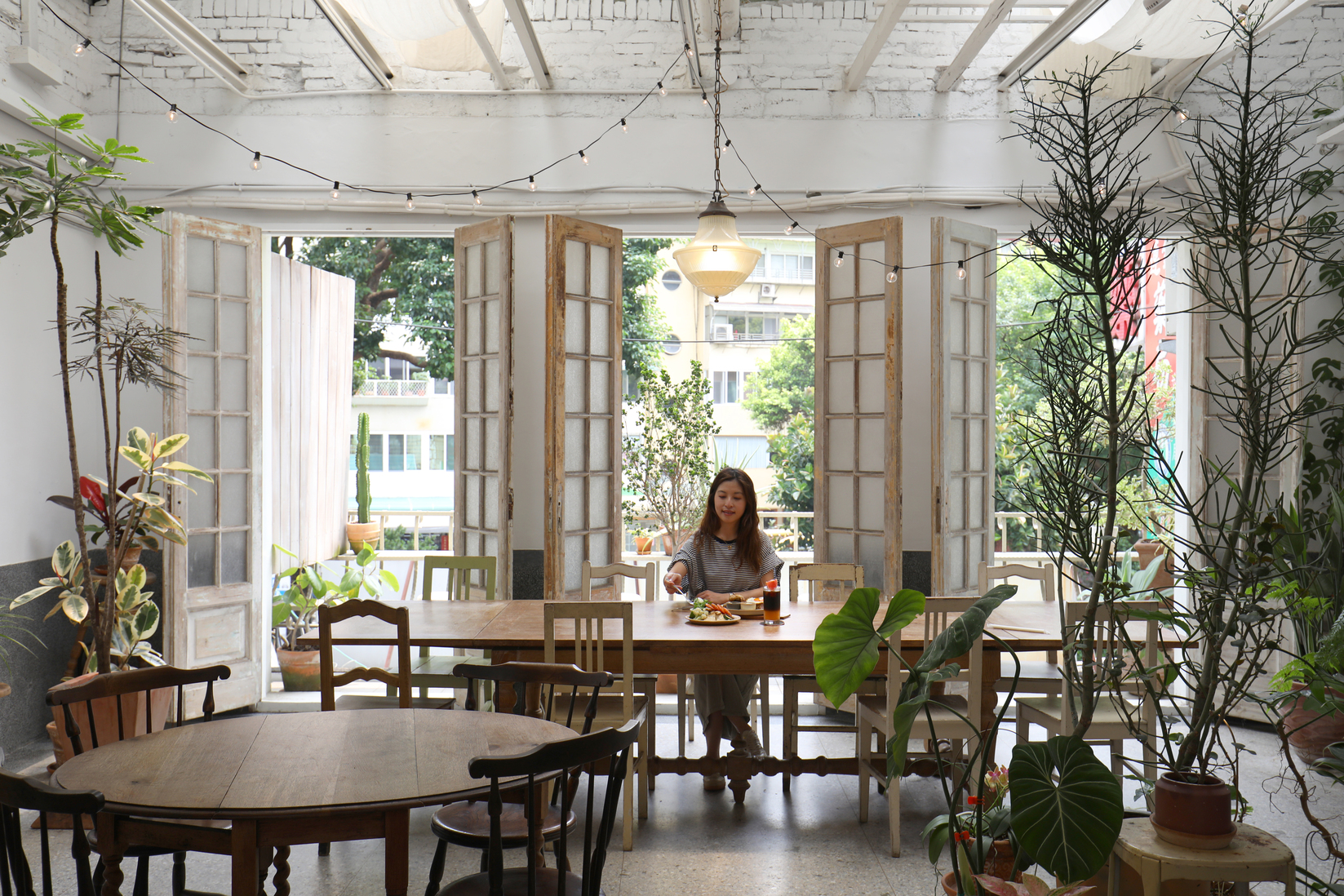 「綠咖生活概念店」老宅裡敞開的3片落地木門，讓空間通風又愜意。
