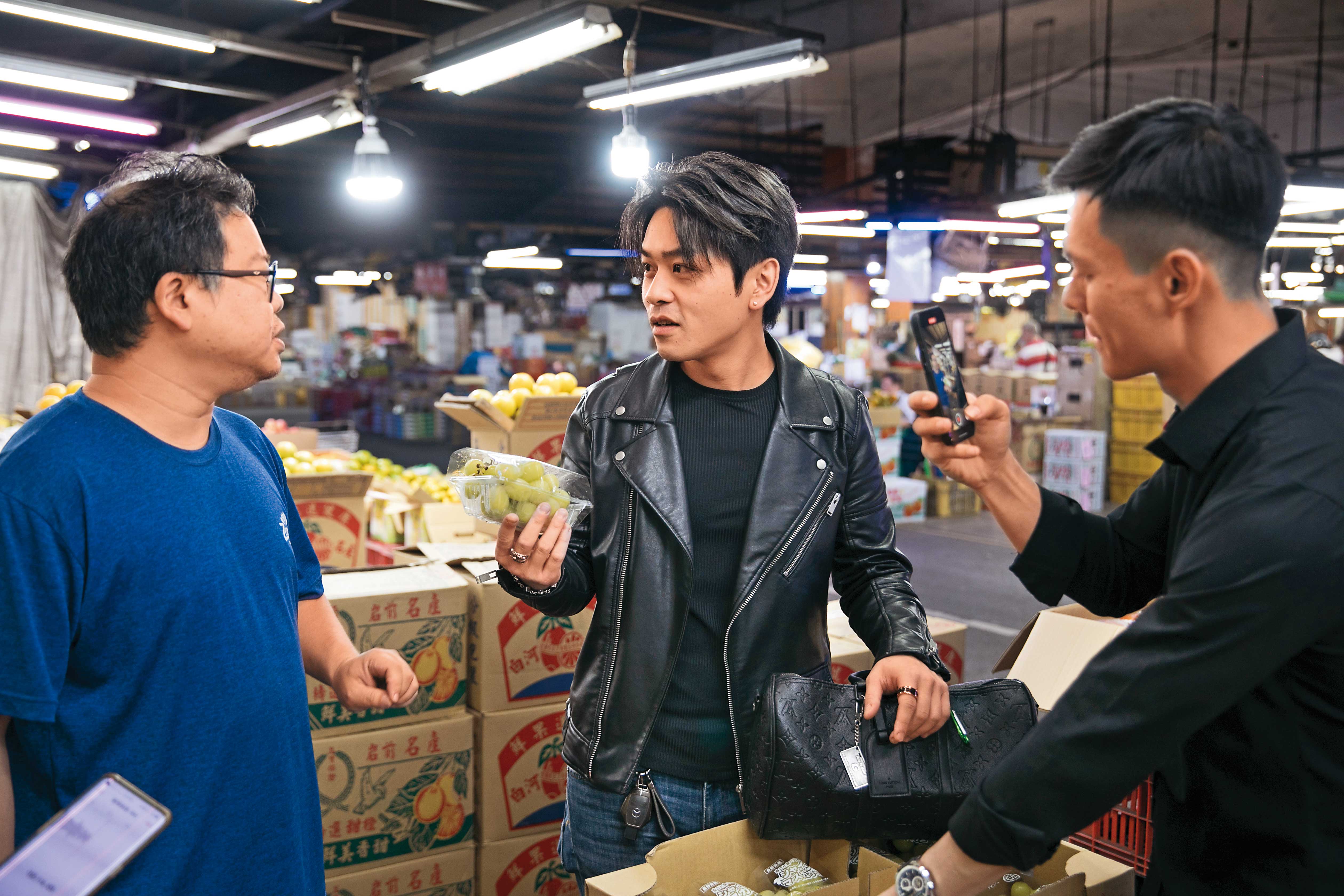 為了截貨，李祖恩（中）凌晨3點就到新北三重果菜市場挑水果，他表示現在氣候變遷下，水果品質不是那麼穩定，只有親挑、試吃才能拿到當季最好的水果。