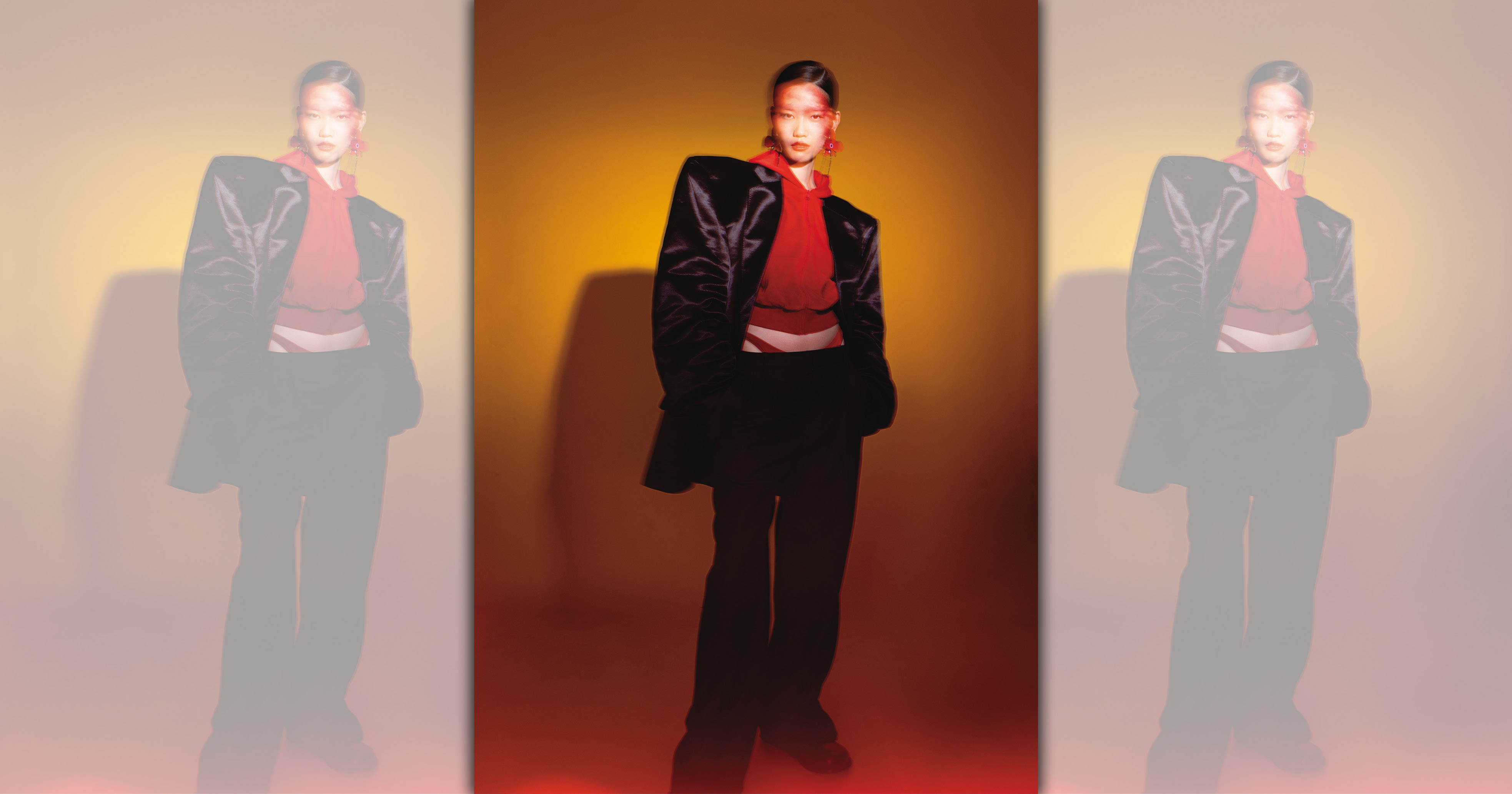 黑色大墊肩外套 NT$139,000 by BALENCIAGA；紅色連帽上衣 NT$67,000 by BALENCIAGA；紅色內搭丁字褲 NT$15,600 by BALENCIAGA；灰色直條紋西裝褲 NT$53,000 by LOEWE；Campo 黑色小牛皮切爾西靴 NT$45,000 by LOEWE；紅色花卉耳環 NT$790 by ZARA。