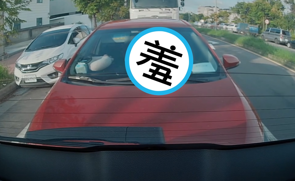 一輛紅色轎車等紅燈時，竟無預警往前滑追撞前車。（翻攝臉書社團「爆廢公社」）