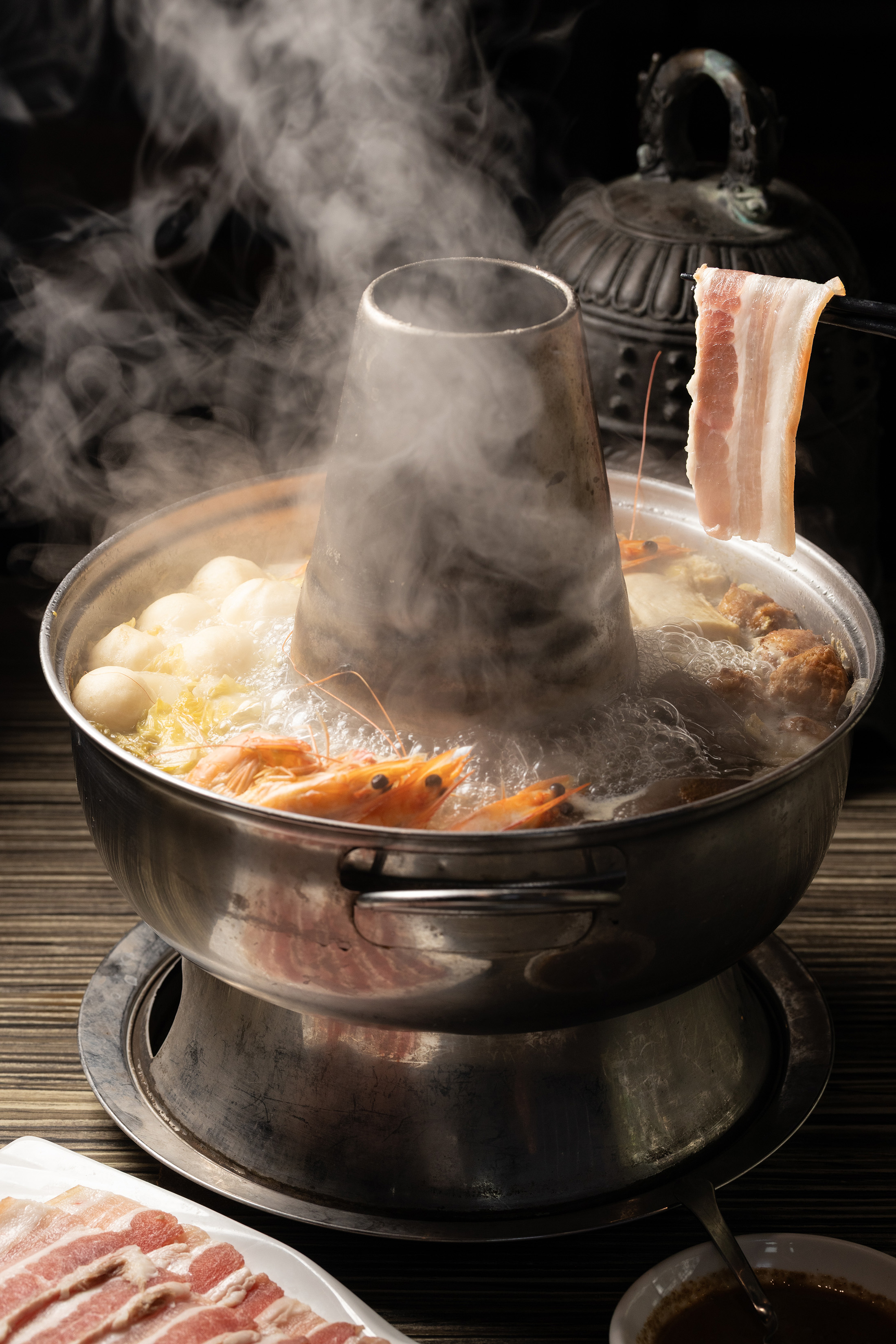 「東北酸菜白肉鍋」使用主廚自製酸白菜、手工炸丸子，以及嚴選的五花肉與寬粉、鴨血、鮮蝦等豐富配料，以炭火慢煮，味道酸甜甘口。（880元／小份）