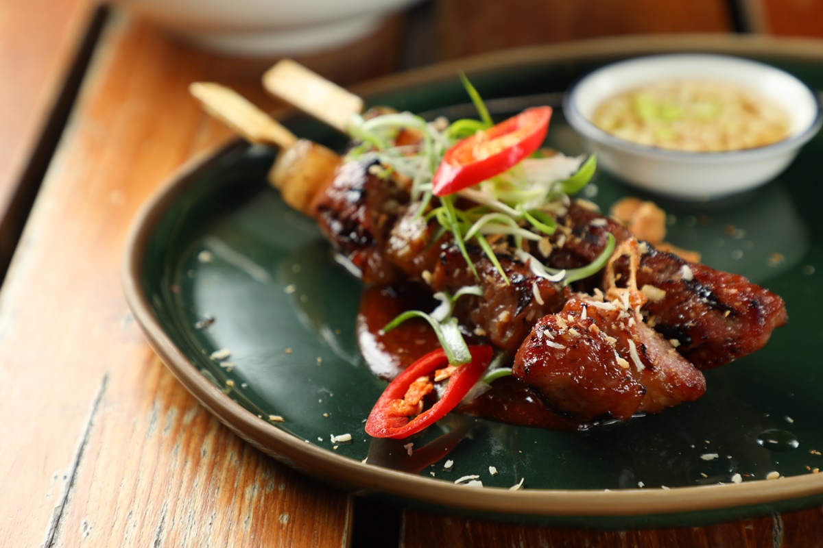 在泰式居酒屋「Praça」必點燒烤豬肉串「Moo Ping Bo Larn」，配上堅果醬料就是美味。（260泰銖／份，約NT$229）