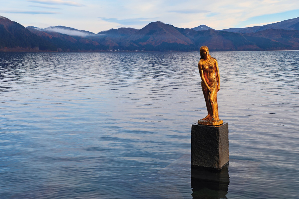 以田沢湖神話傳說中的少女打造的辰子像，背景是四季變化的湖光山色。