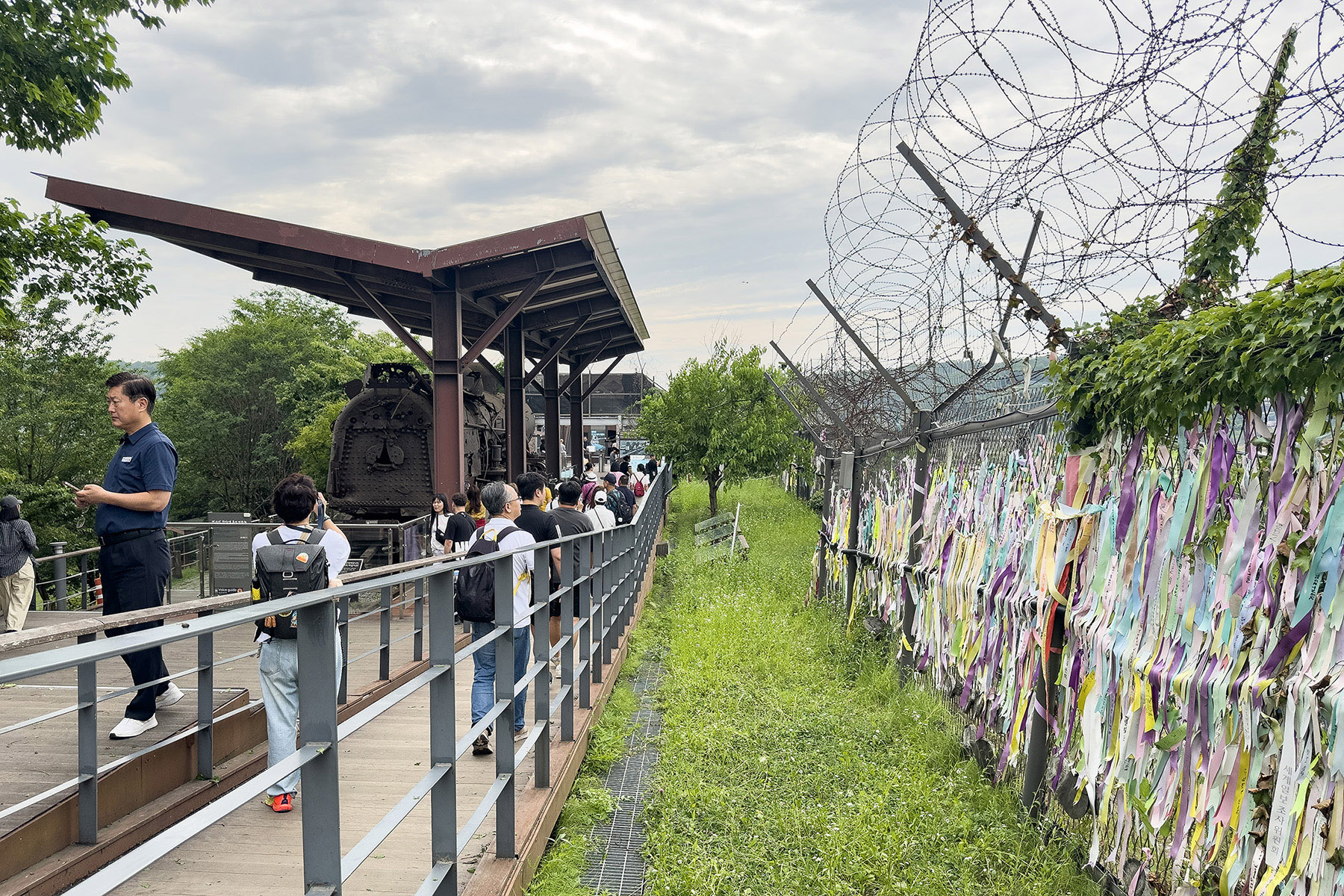 自由之橋下方的長廊除了展示蒸汽火車，鐵絲網上也掛著來自世界各地對和平的嚮往與祈願。