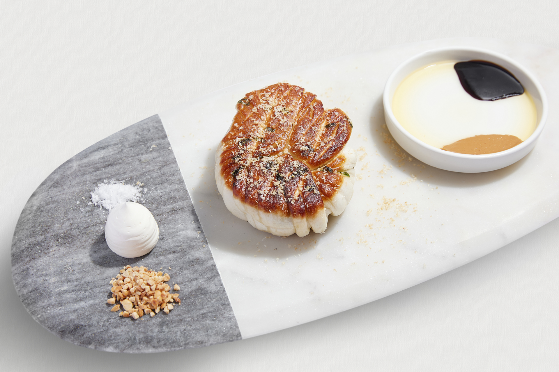 「archi藝廚」套餐中的「招牌蔥花捲」加入三星蔥手工揉製，煎至金黃酥香，佐榛果碎與花生醬沾醬，將蔥花捲昇華到美味新境界。（archi 藝廚提供）