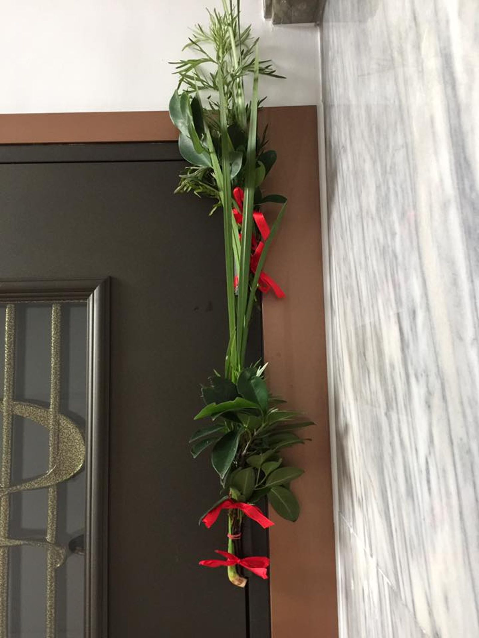 端午當日,許多人習慣在門上掛菖蒲、艾草與榕樹葉來避邪。(鏡好聽提供)