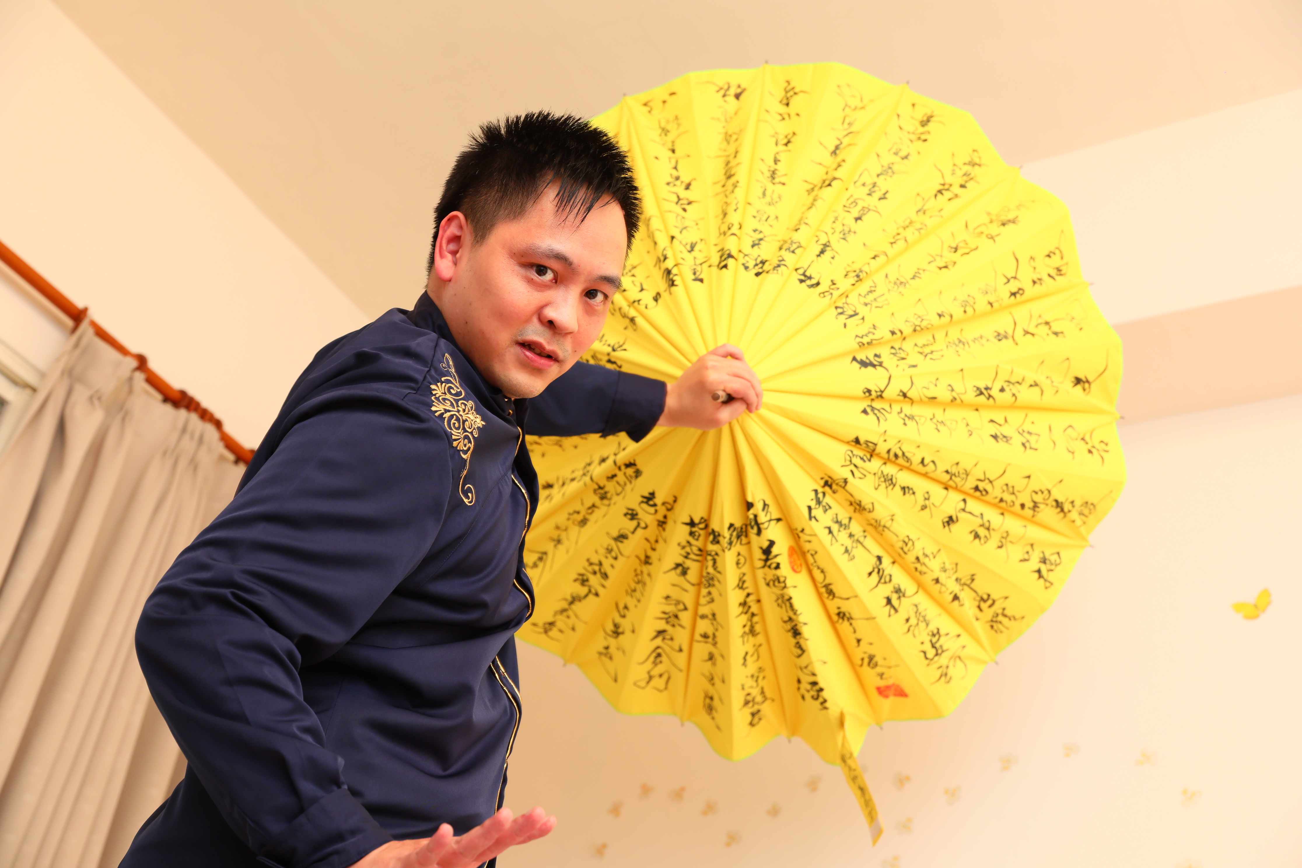 黃信凱應我們要求翻出魔術道具擺了個帥氣姿勢,他笑說,曾在表演這個從身後抽出12把雨傘的魔術時,出槌掉了一把,影片還被放上網流傳。