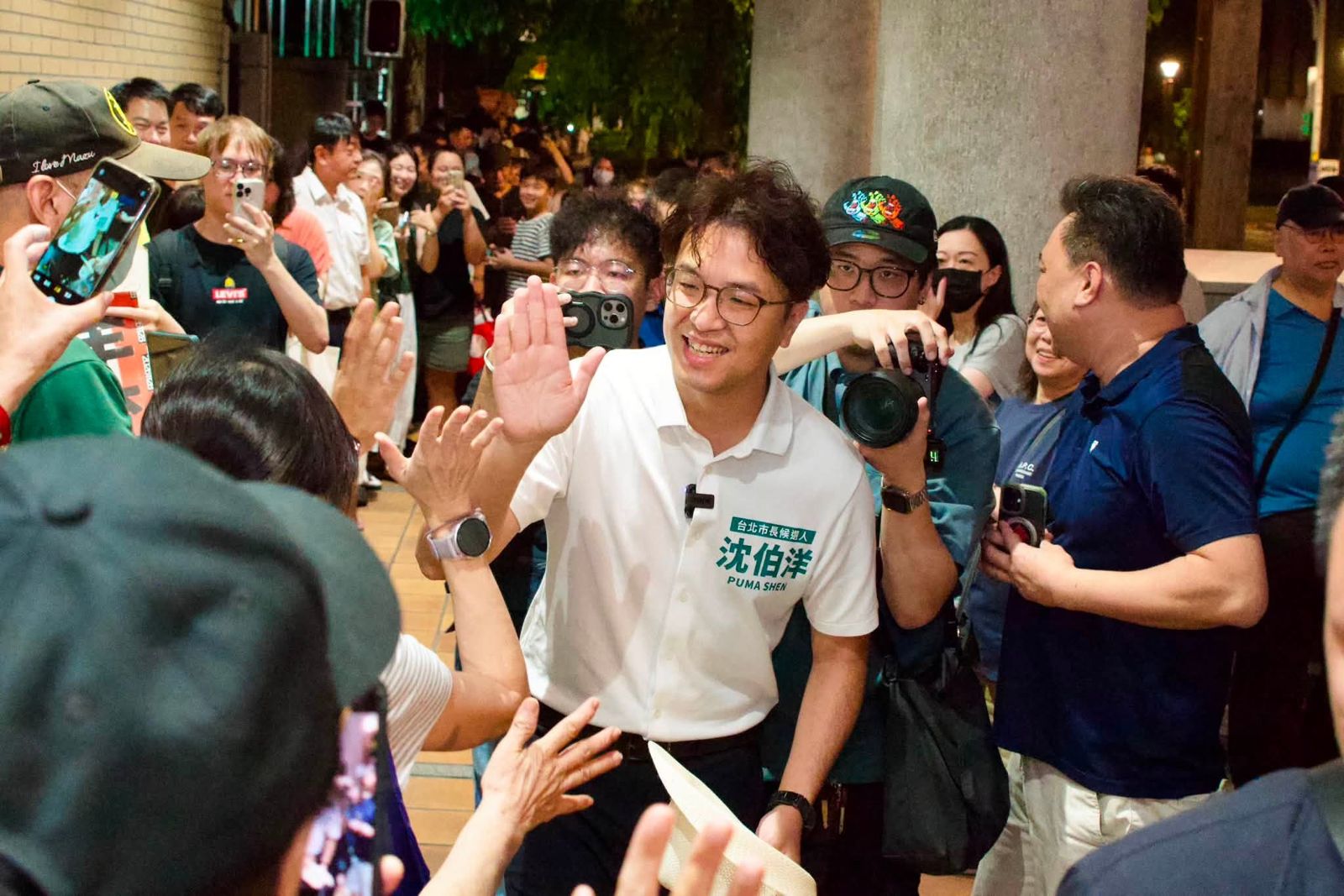 民進黨台北市長參選人沈伯洋近日赴寧夏夜市掃街受到熱烈歡迎,現場民眾與他擊掌。(翻攝臉書「台北 沈伯洋」)