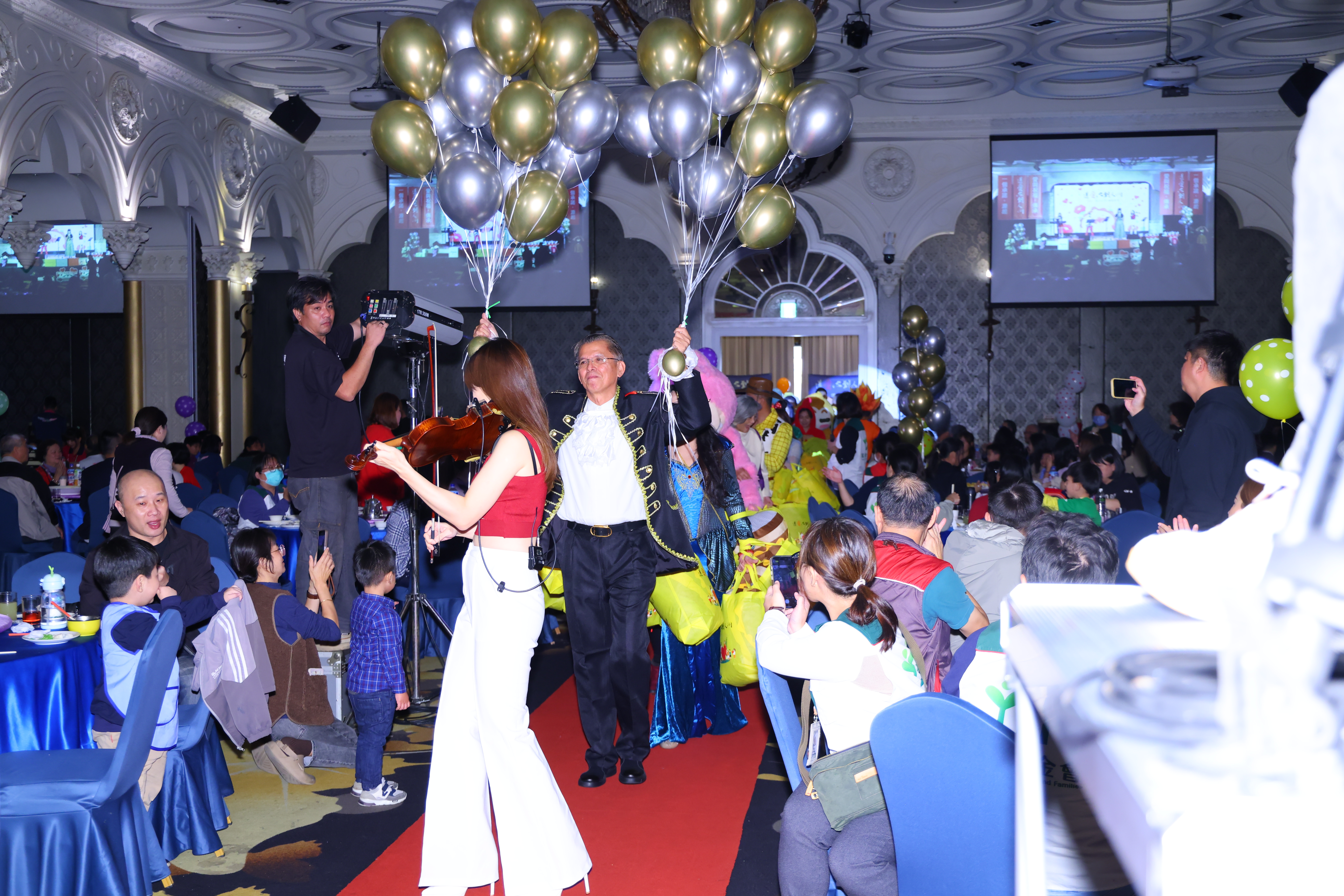 精湛建設總經理陳志聲（中手持氣球者）為遲緩兒和盲童辦年末公益活動已26年。（精湛建設提供）