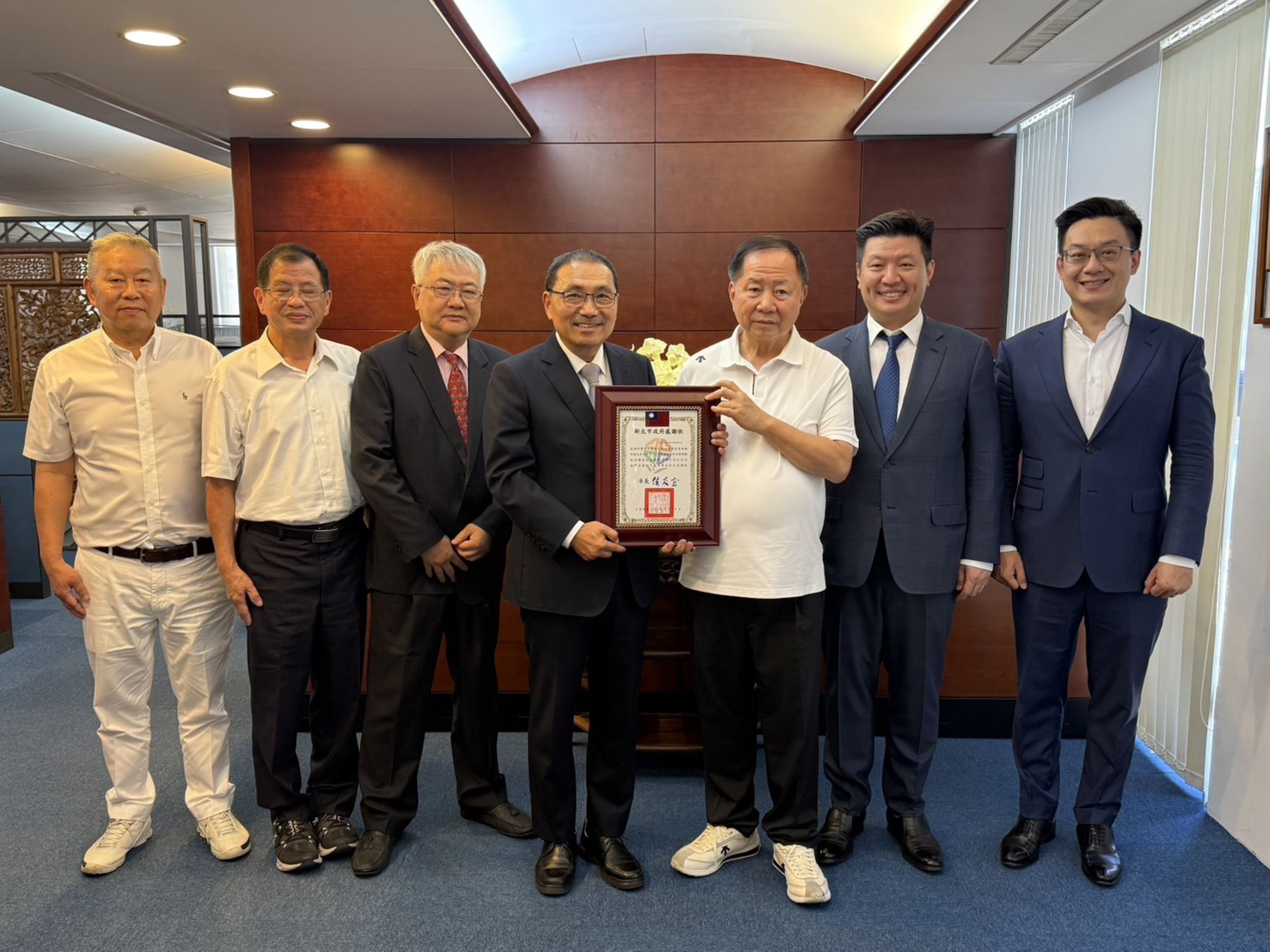 新北市長侯友宜(左4)14日率消防局長陳崇岳(左2),前往薇閣基金會,向對殉職勇消家屬伸出援手的李傳洪(右3)致意。右2為薇閣基金會董事李承宗。(薇閣基金會提供)