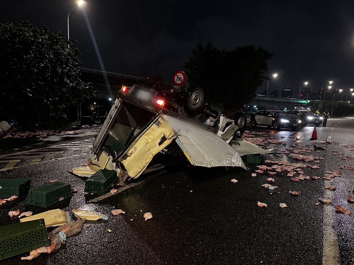 翁男駕駛滿載生鮮雞腿的貨車，今晨不慎自撞護欄翻覆。（翻攝畫面）