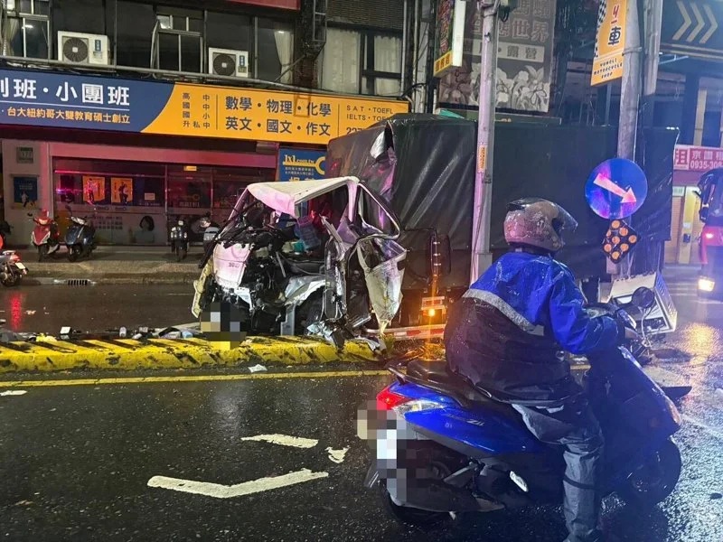 貨車撞上分隔島並衝至對向車道，車頭受猛烈撞擊成了廢鐵。（翻攝畫面）