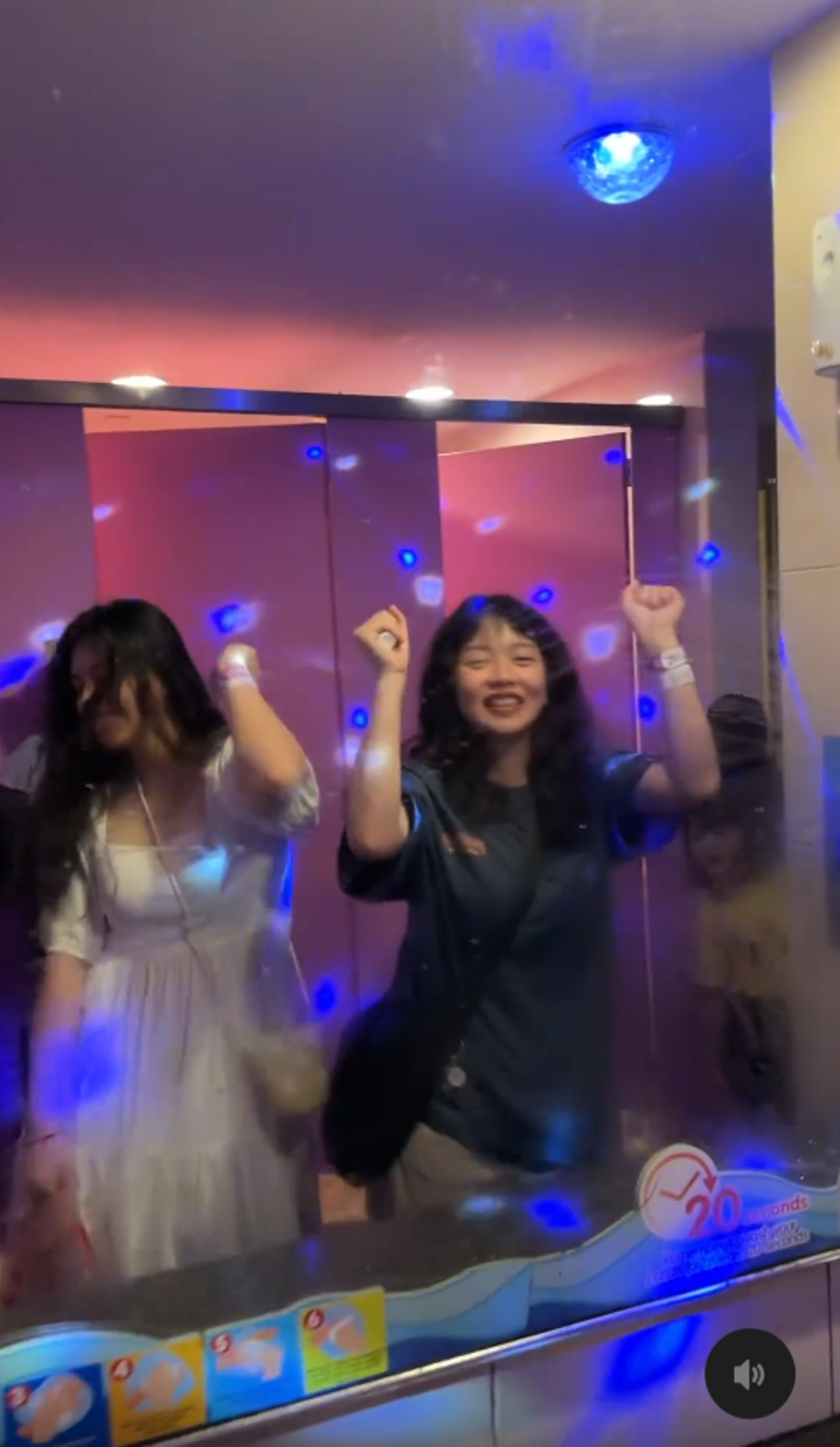 兩名台灣女子按下紅色按鈕後，廁所秒變夜店，可隨著音樂起舞。（翻攝whaatis.it Threads）