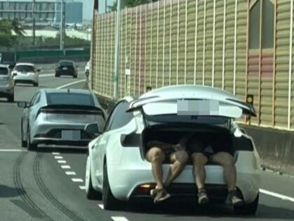 有民眾日前在國道目擊一輛特斯拉用後車廂載運2名男子。（翻攝畫面）