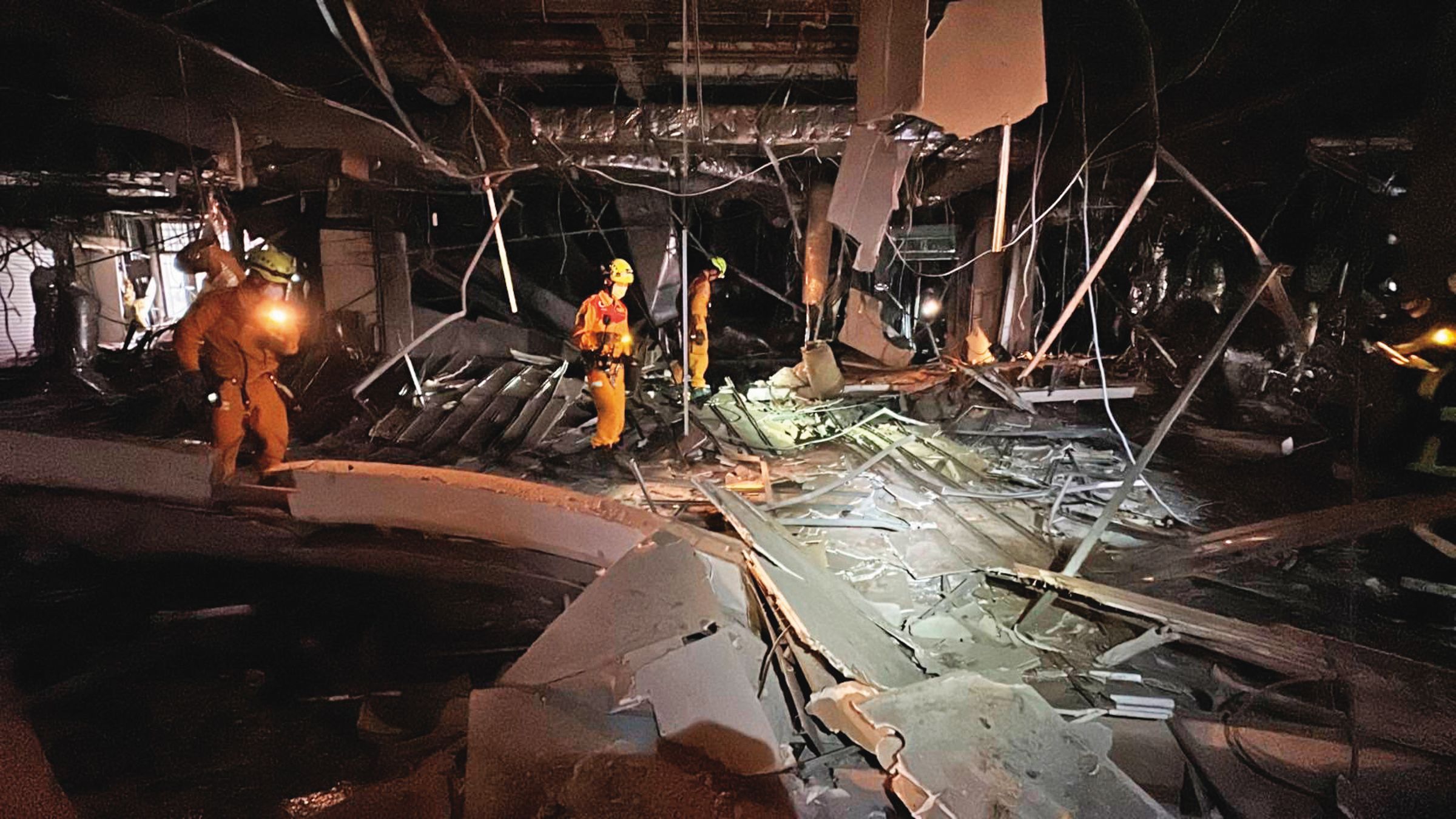 消防人員在氣爆樓層仔細搜索，確認是否還有人員受困。（台中市消防局提供）