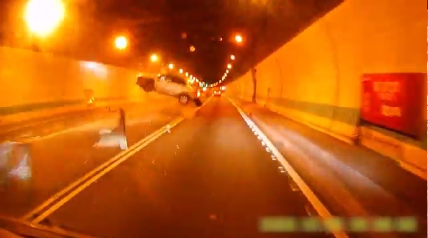 張男去年底在國道5號自撞木柵隧道內側後翻車，因未繫安全帶而從破碎的天窗拋飛。（翻攝畫面）