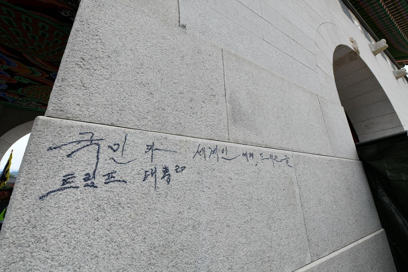 韓國首爾代表性古蹟光化門11日上午遭人以黑色馬克筆塗鴉。（翻攝韓網）