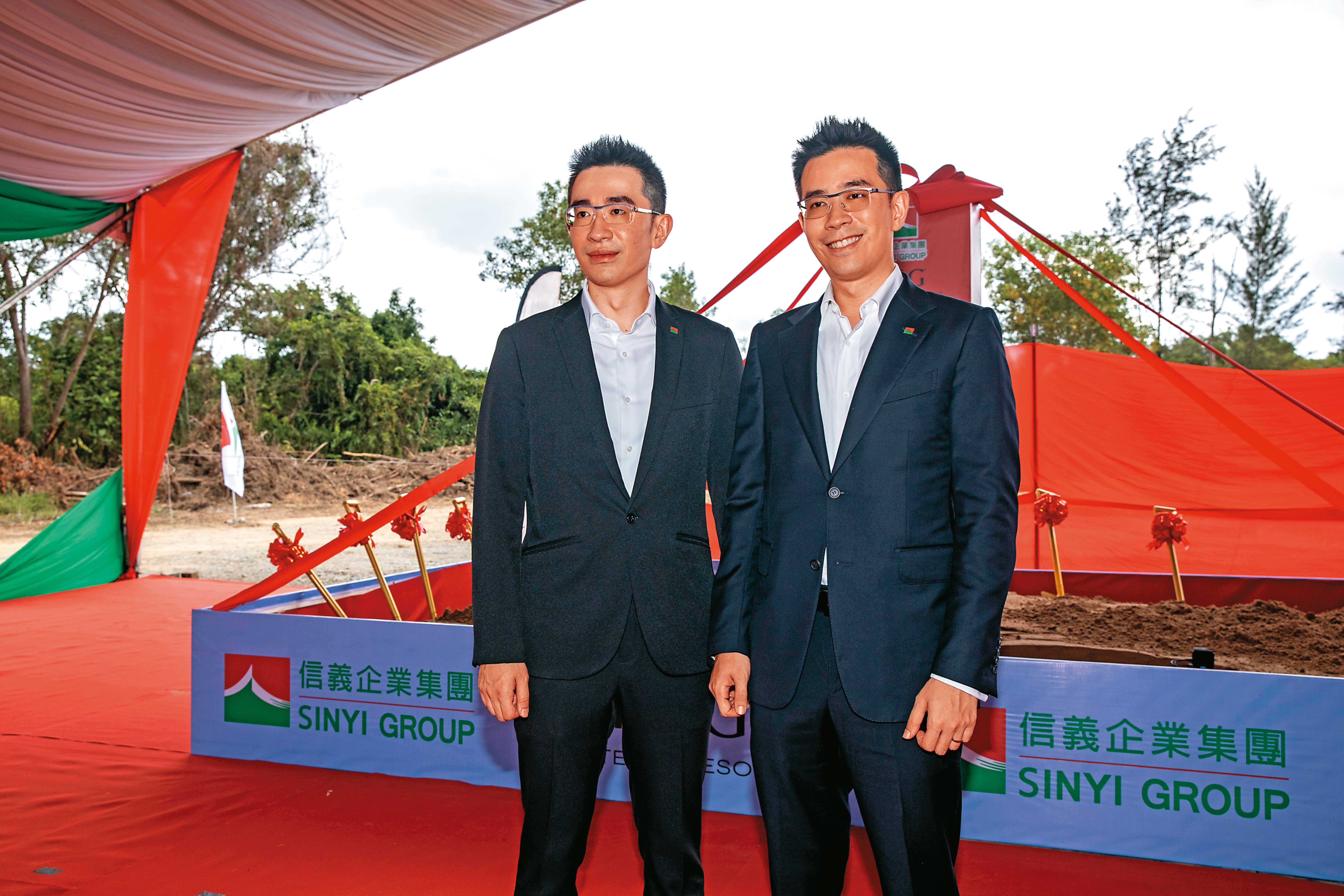 周耕宇（左）和弟弟周君澔（右）分工，他掌管房仲本業，周君澔長駐馬來西亞，替集團開拓觀光事業。