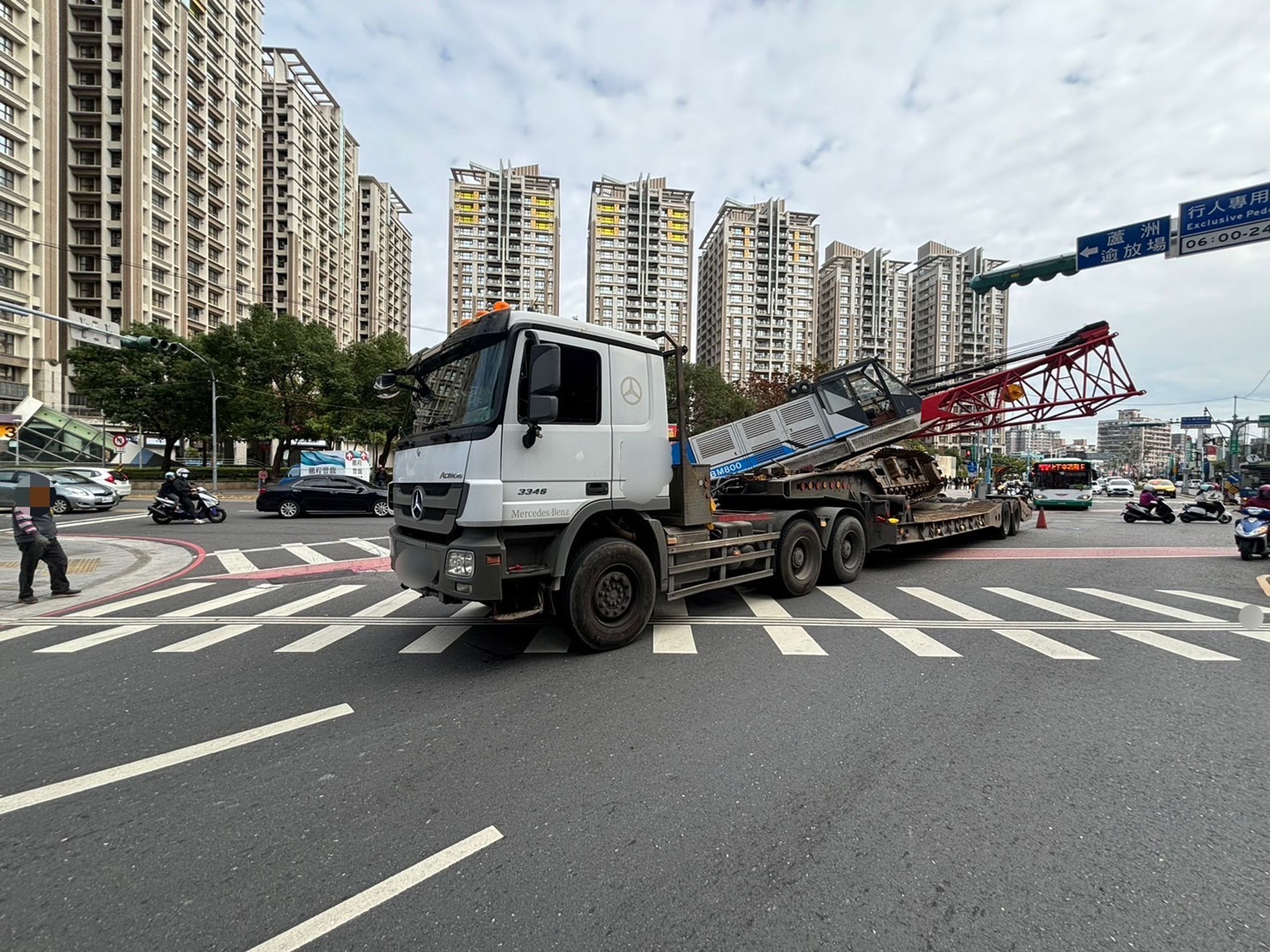 吊車傾斜掉落畫面太驚險,吸引民眾駐足圍觀。(警方提供)