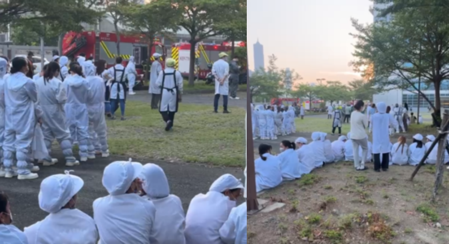 高雄華新科技工廠清晨突起火，警報聲大作，員工穿著防塵衣緊急逃出，消防人員火速灌救。（翻攝畫面）