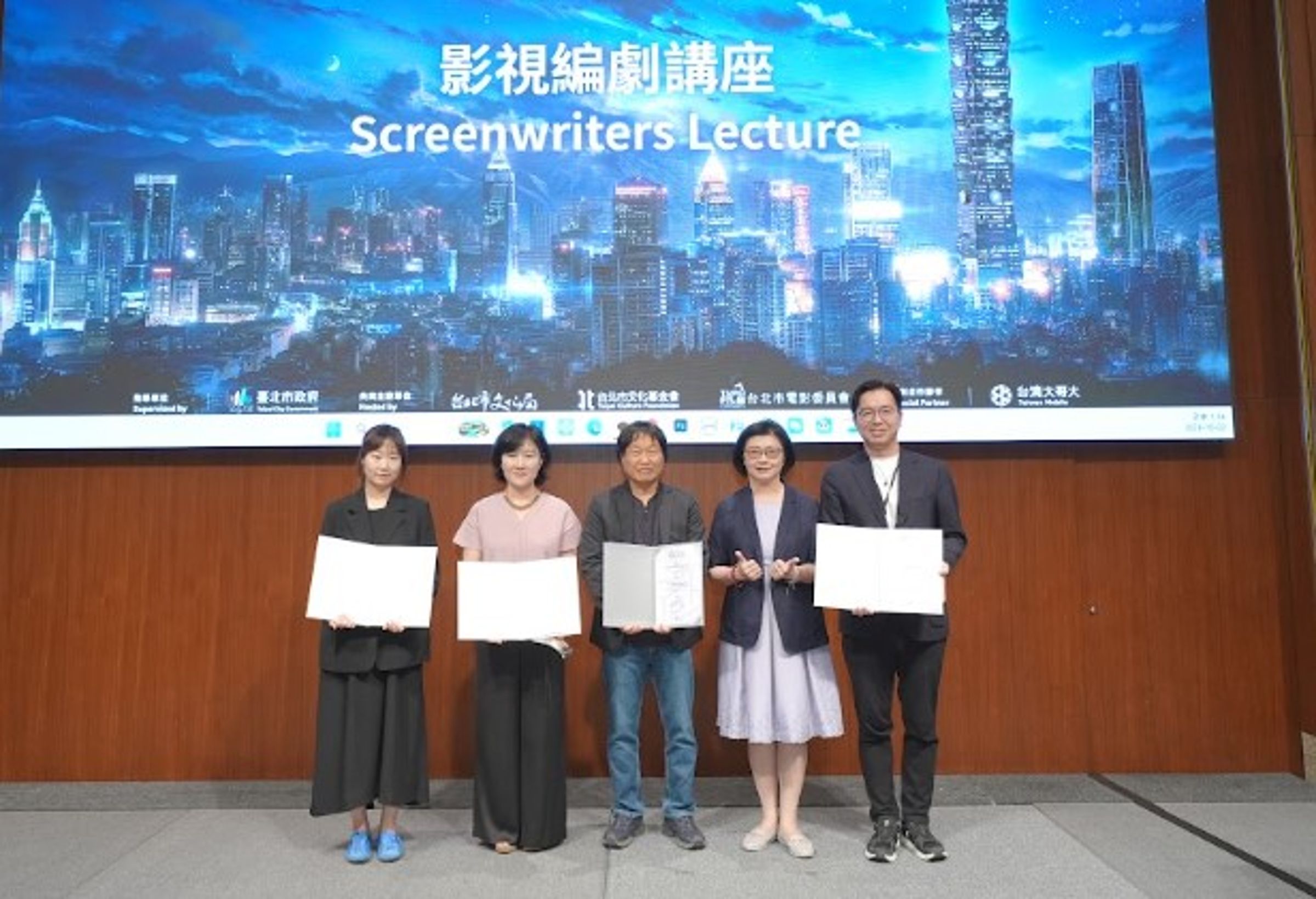 台北市電影委員會總監饒紫娟（右二）頒贈感謝狀給台灣大哥大內容發展副總經理鄭偉柏（右起）、導演郭在容、編劇朴海英與製作人黃羅慶。（台北市電影委員會提供）