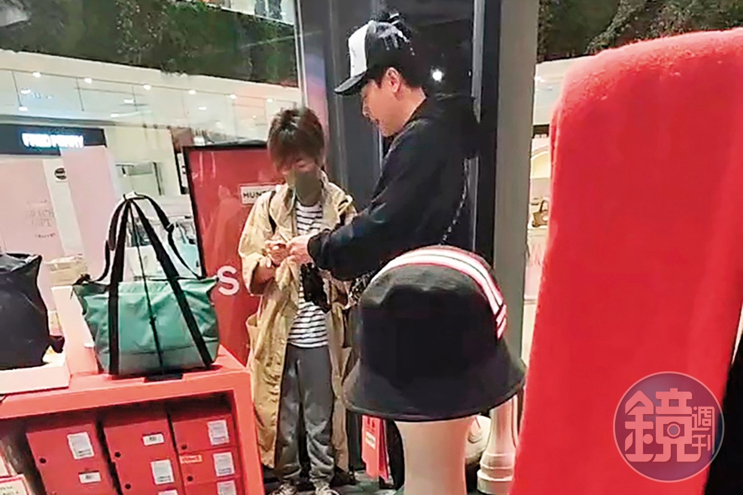 女友人在店內仔細看包,王振復在一旁不時給意見。(讀者提供)