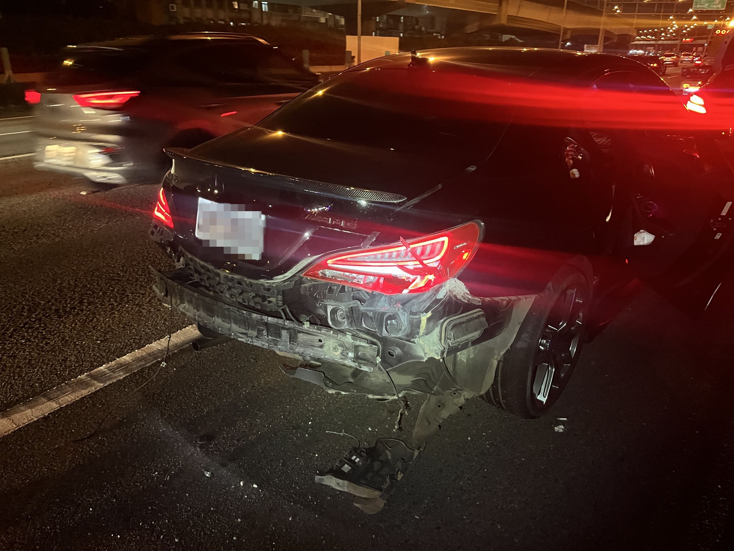 2車車速很快,擦撞事故造成黑色賓士車車尾保險桿掉落。翻攝畫面