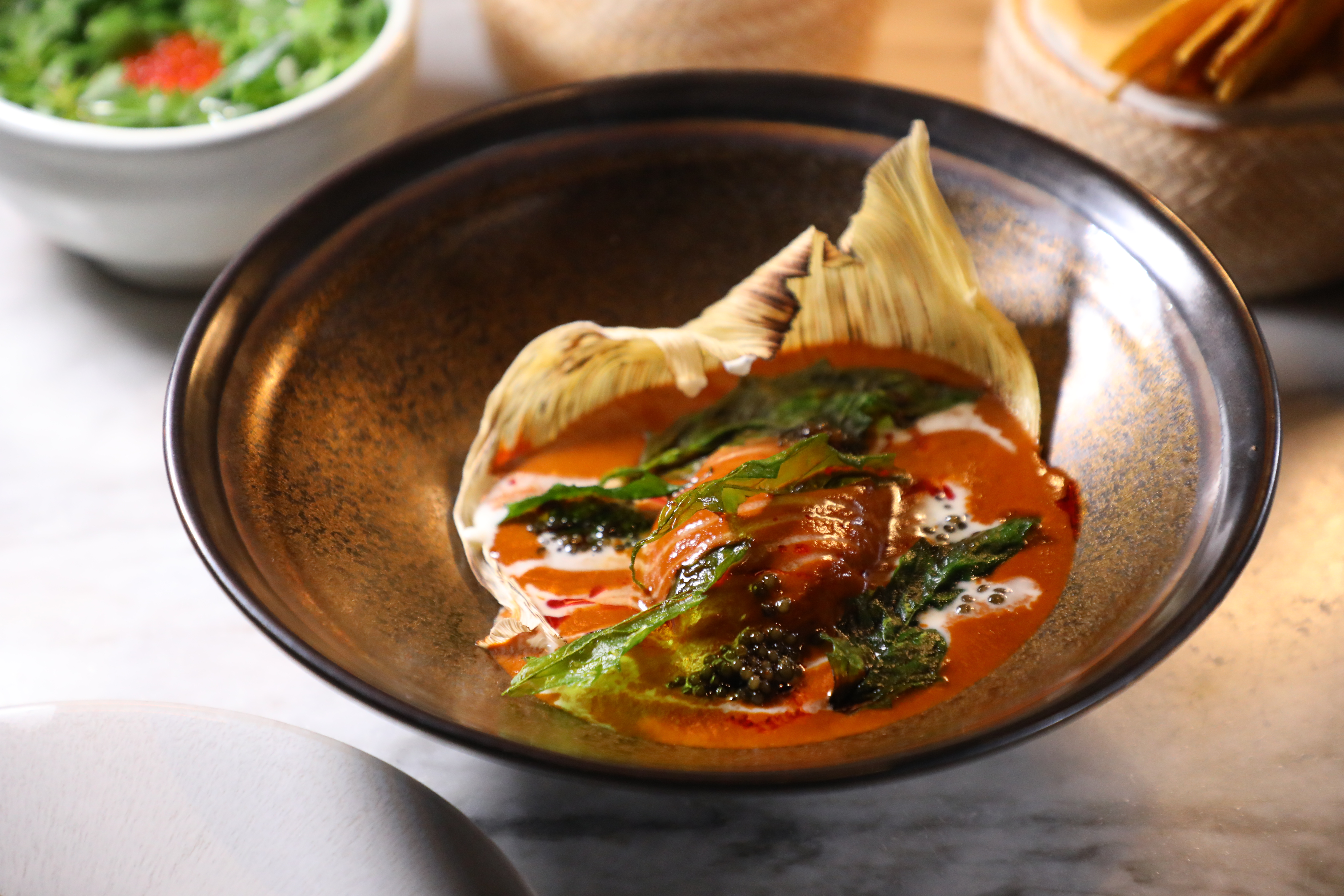 以Salsa Roja紅醬、法國奧賽嘉魚子醬、新鮮起司、臭草製作的「Uchepo Corn Tamal」。(800泰銖/份,約NT$707)