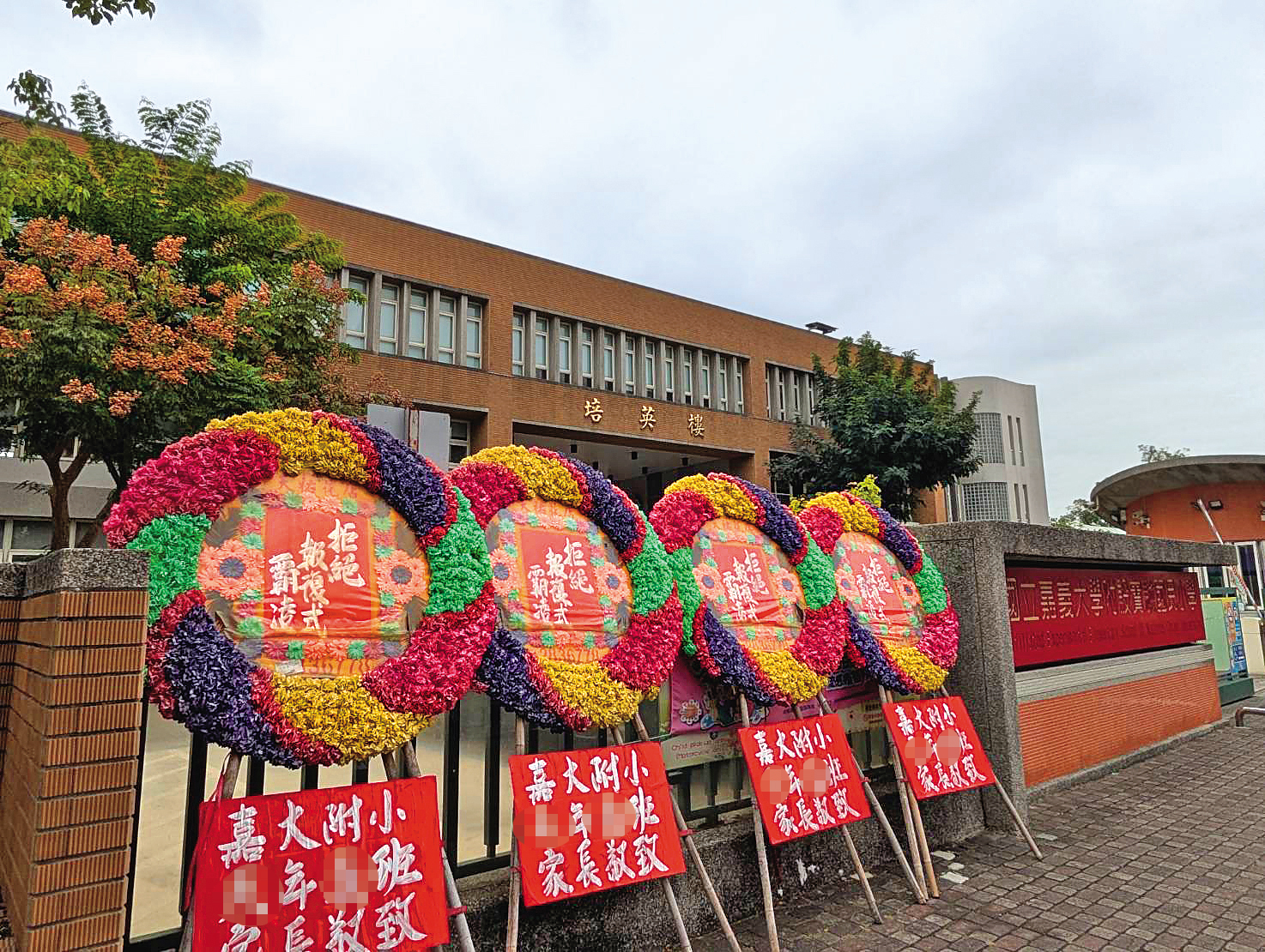 許多家長購買花圈擺在學校周遭，希望幫H老師加油打氣，也盼真相能水落石出。（讀者提供）
