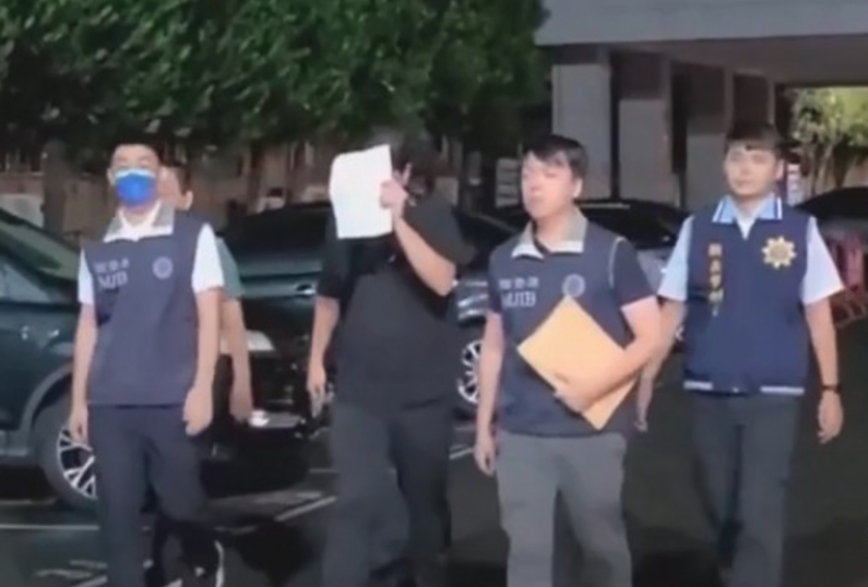 新北市刑大陳姓偵查佐涉侵占毒品遭羈押禁見，陳昨移送地檢署時以紙迅遮臉。（鏡新聞提供）