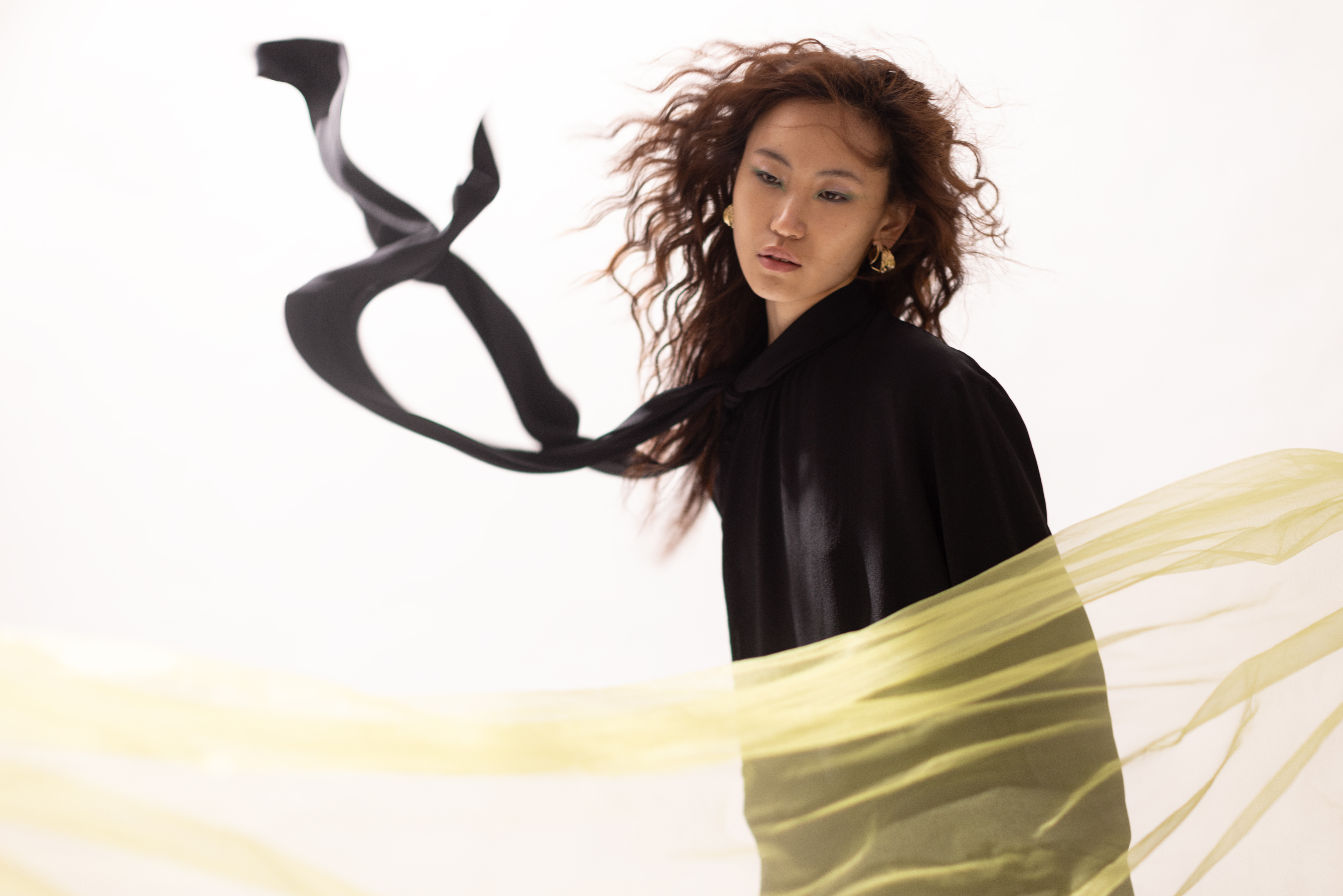 黑色造型連身洋裝 NT$819,00、金色耳環 NT$15,900 ，all by FERRAGAMO。