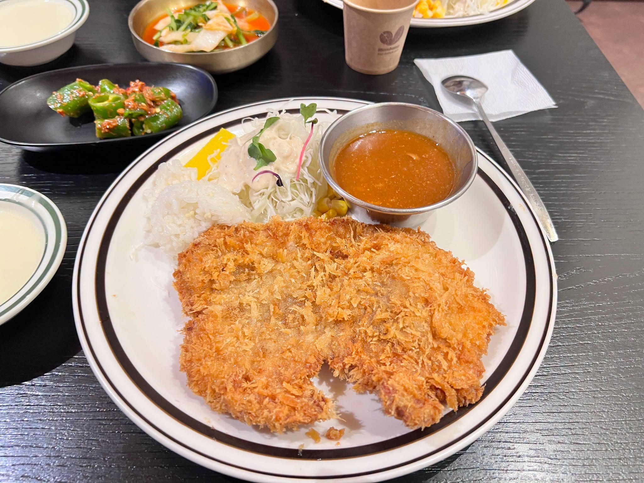 部落客帶兒子到韓國吃咖哩豬排,沒想到店員誤會她吃不飽,暖心送上一整份豬排。(翻攝自臉書不奇而遇 Steven & Sia)