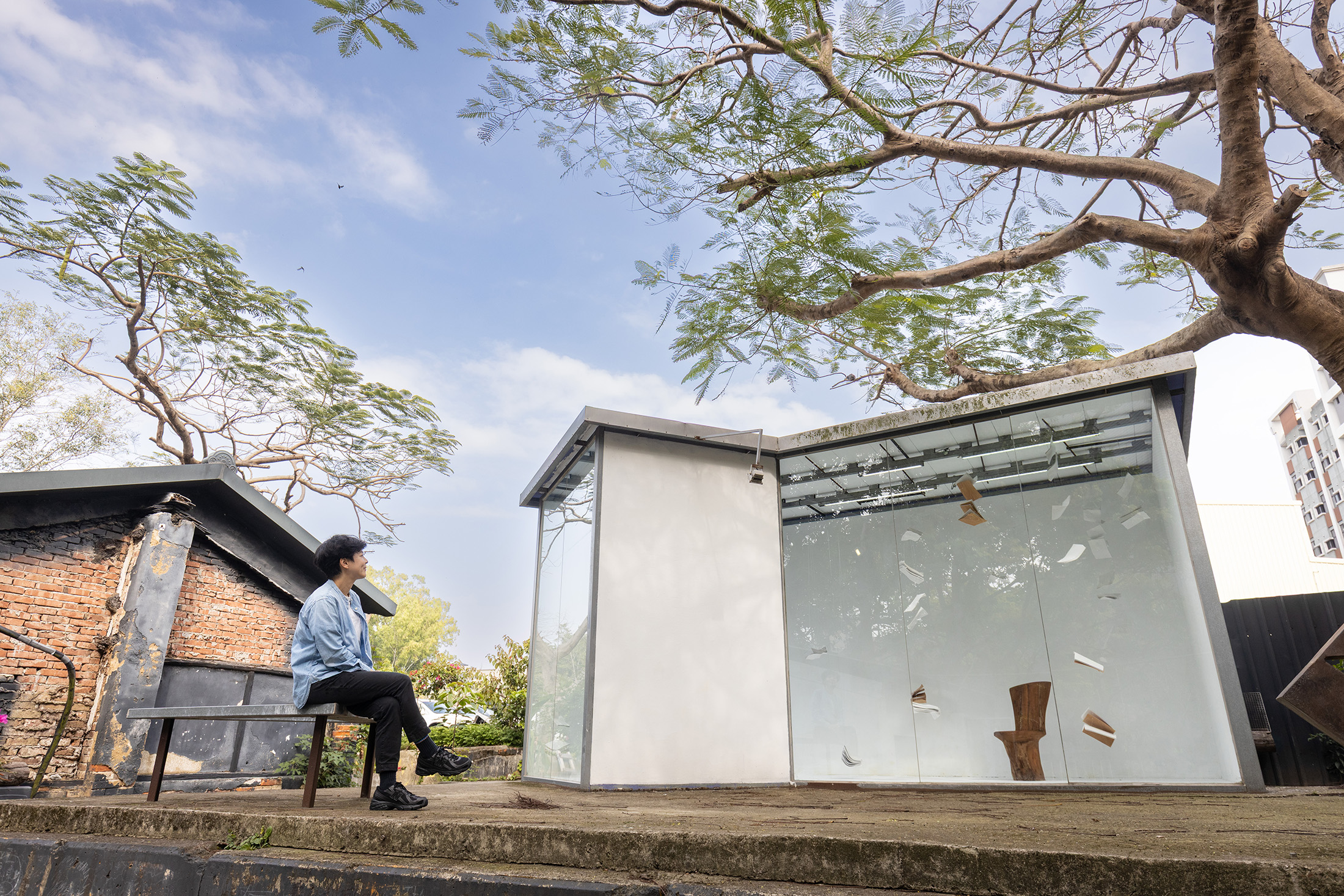 「Frontier邊境黑白切咖啡」最大特色是在庭院樹下打造了一間玻璃屋藝廊，為藝術家提供無償的展示空間。