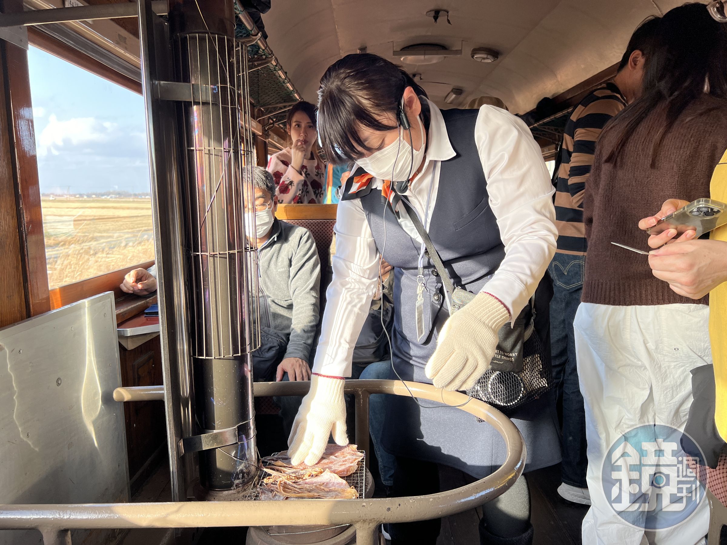 列車員負責幫大家燒烤魷魚。